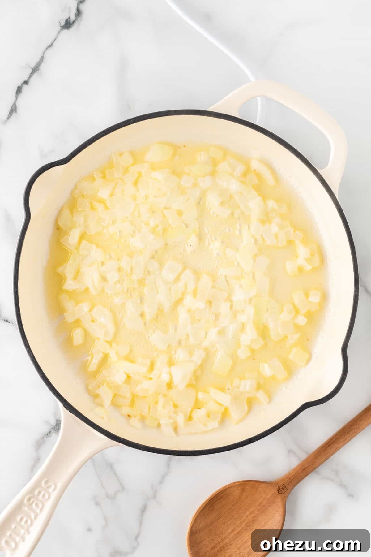 adding garlic and onion to the skillet