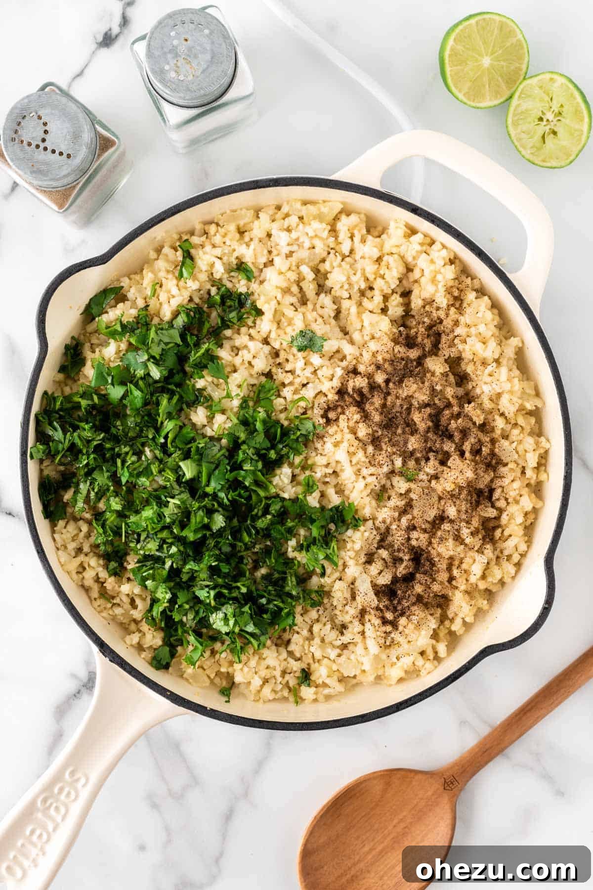 adding the cilantro, lime, and spices to the cauliflower rice
