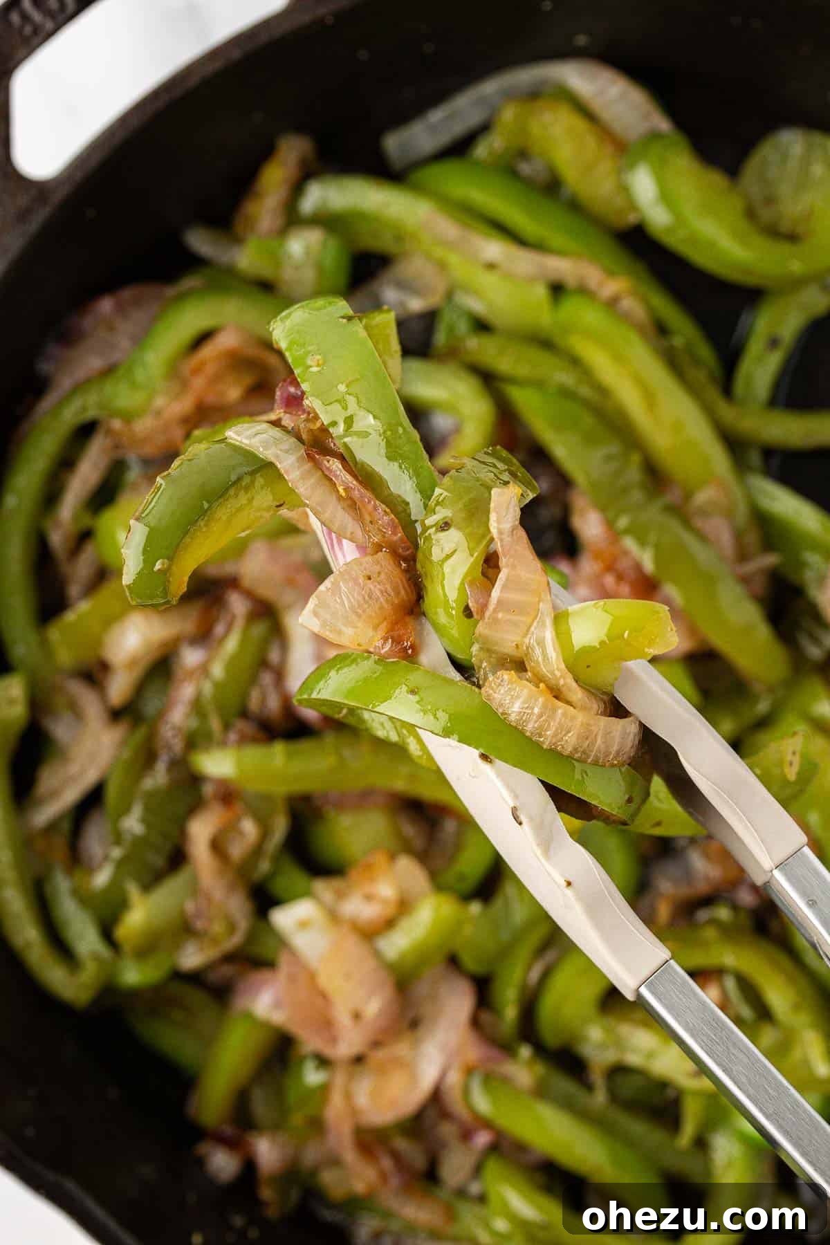 Zesty Fajita Medley 3 Scooping perfectly sautéed fajita vegetables from a hot skillet