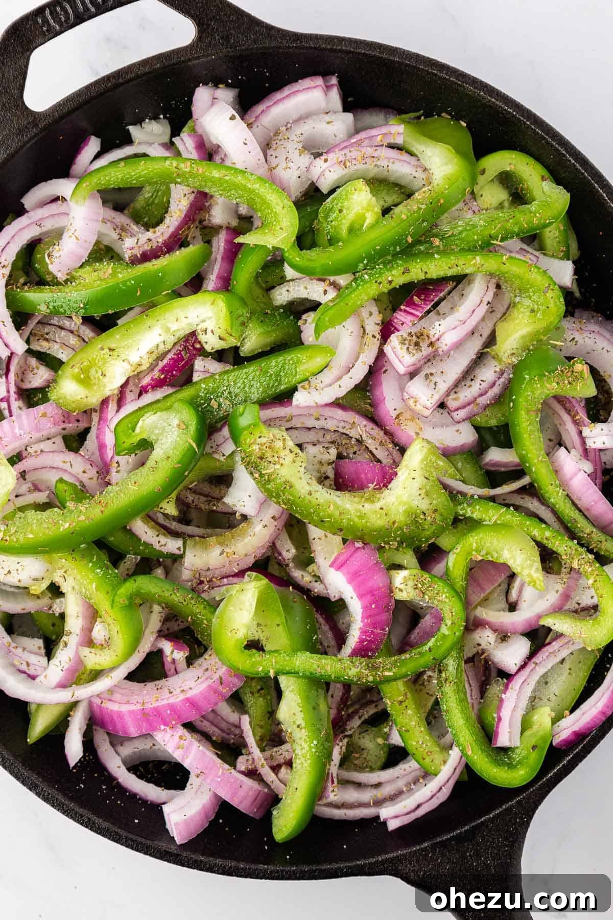 Zesty Fajita Medley 6 Sliced green bell pepper, red onion, and spices arranged in a skillet before cooking.