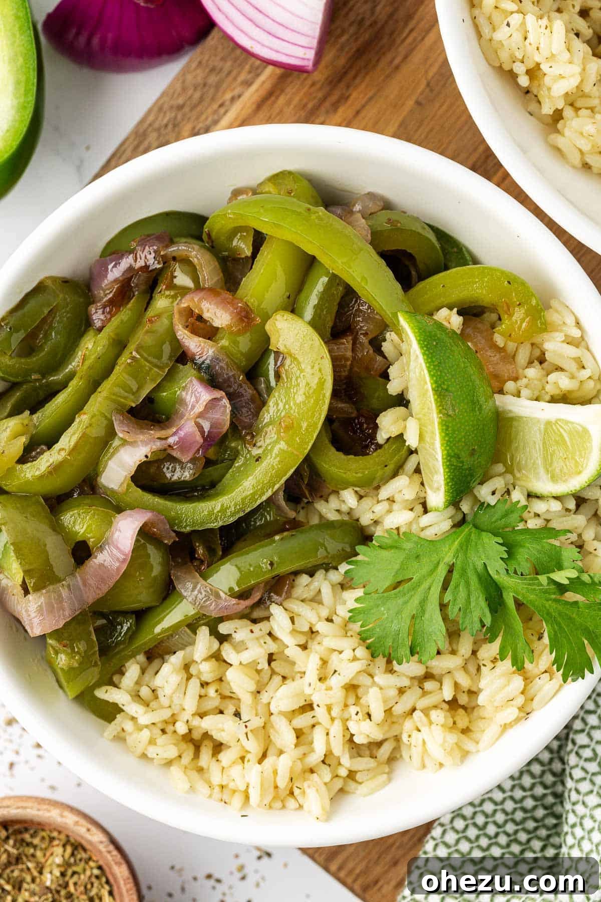 Zesty Fajita Medley 9 A serving of homemade fajita veggies alongside fluffy white rice in a bowl, ready to be customized.