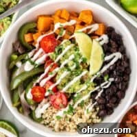 Cauliflower rice burrito bowl with black beans, fajita veggies, sweet potatoes, and guacamole