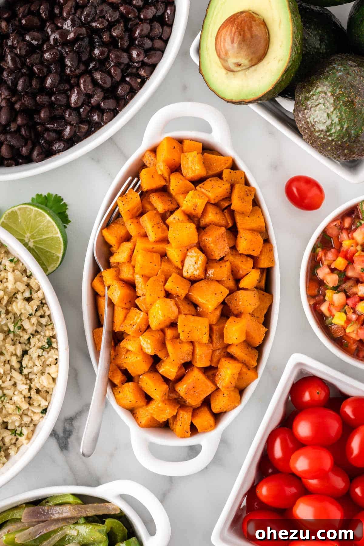 Roasted sweet potatoes in a serving dish, golden brown and tender.