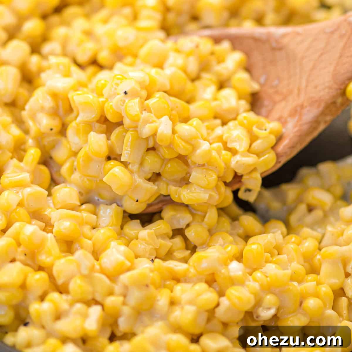 Honey Butter Skillet Corn served on a wooden spoon, showcasing its creamy texture