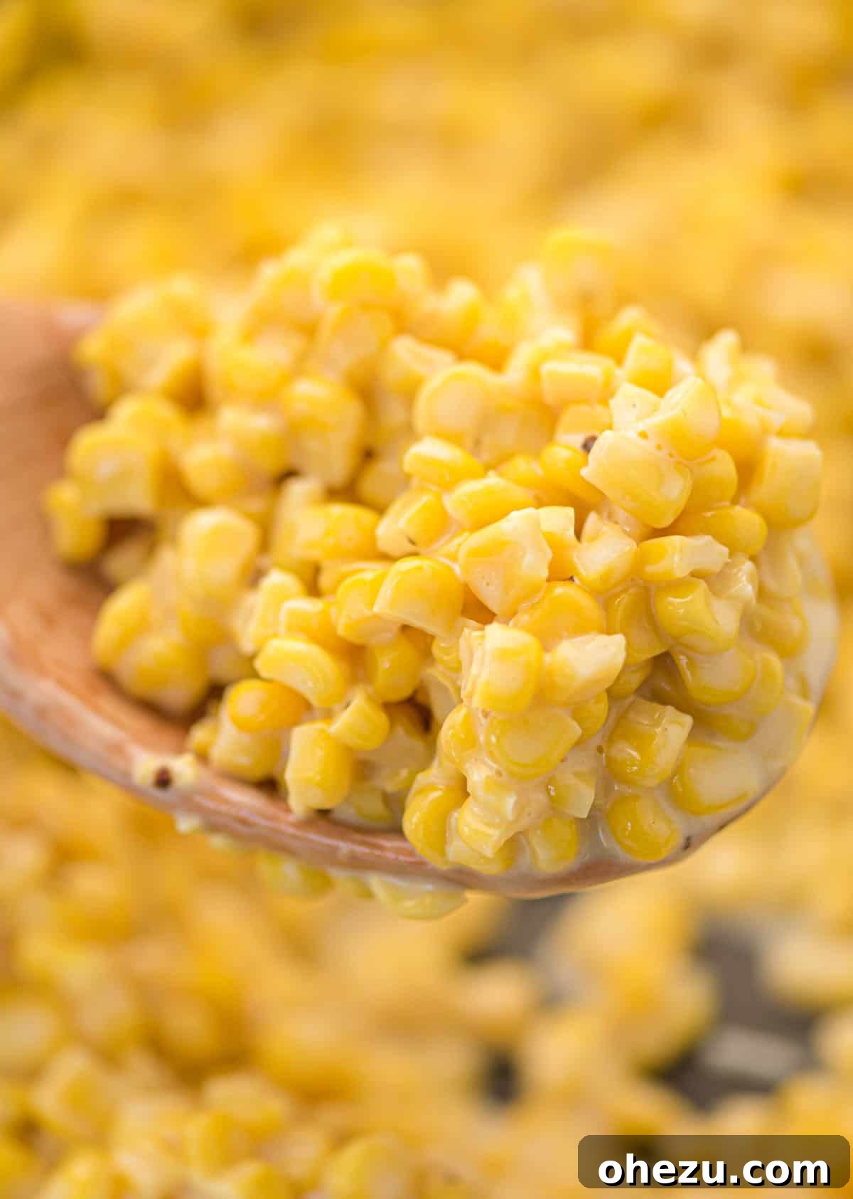 A serving of honey butter corn on a spoon, showcasing its rich texture