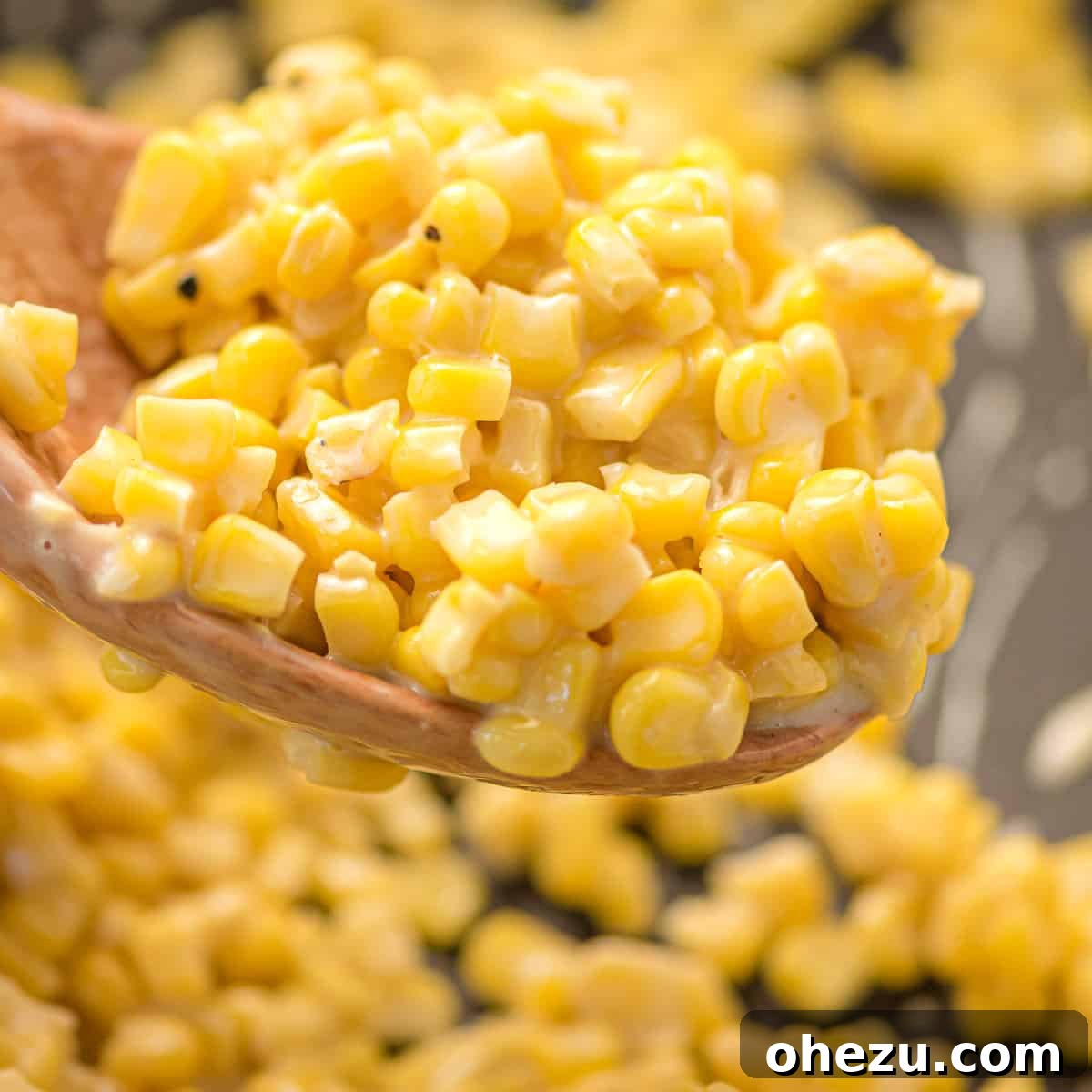 A bowl of honey butter corn with a spoon, highlighting its creamy texture and inviting presentation