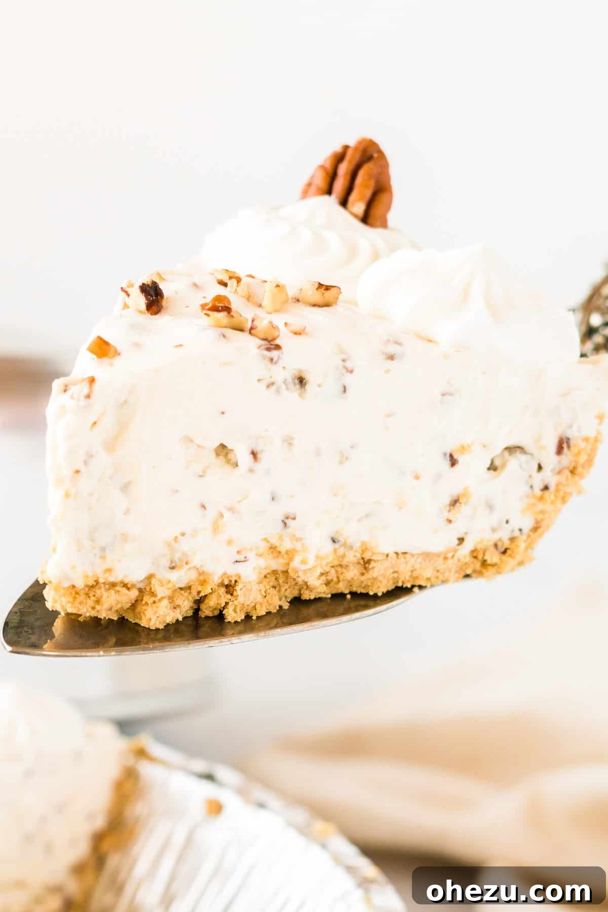 taking a slice of pecan cream pie from the dish