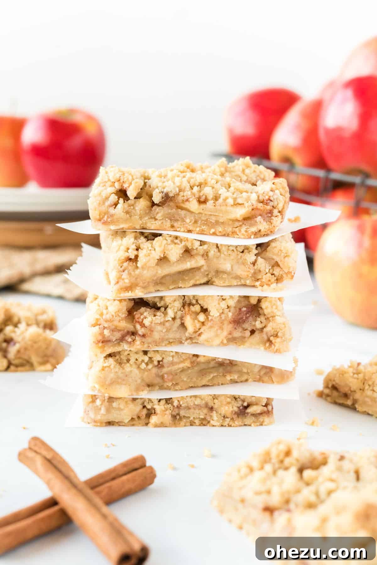 Close-up of apple crisp bars, showing the distinct layers of shortbread crust, apple filling, and crumb topping
