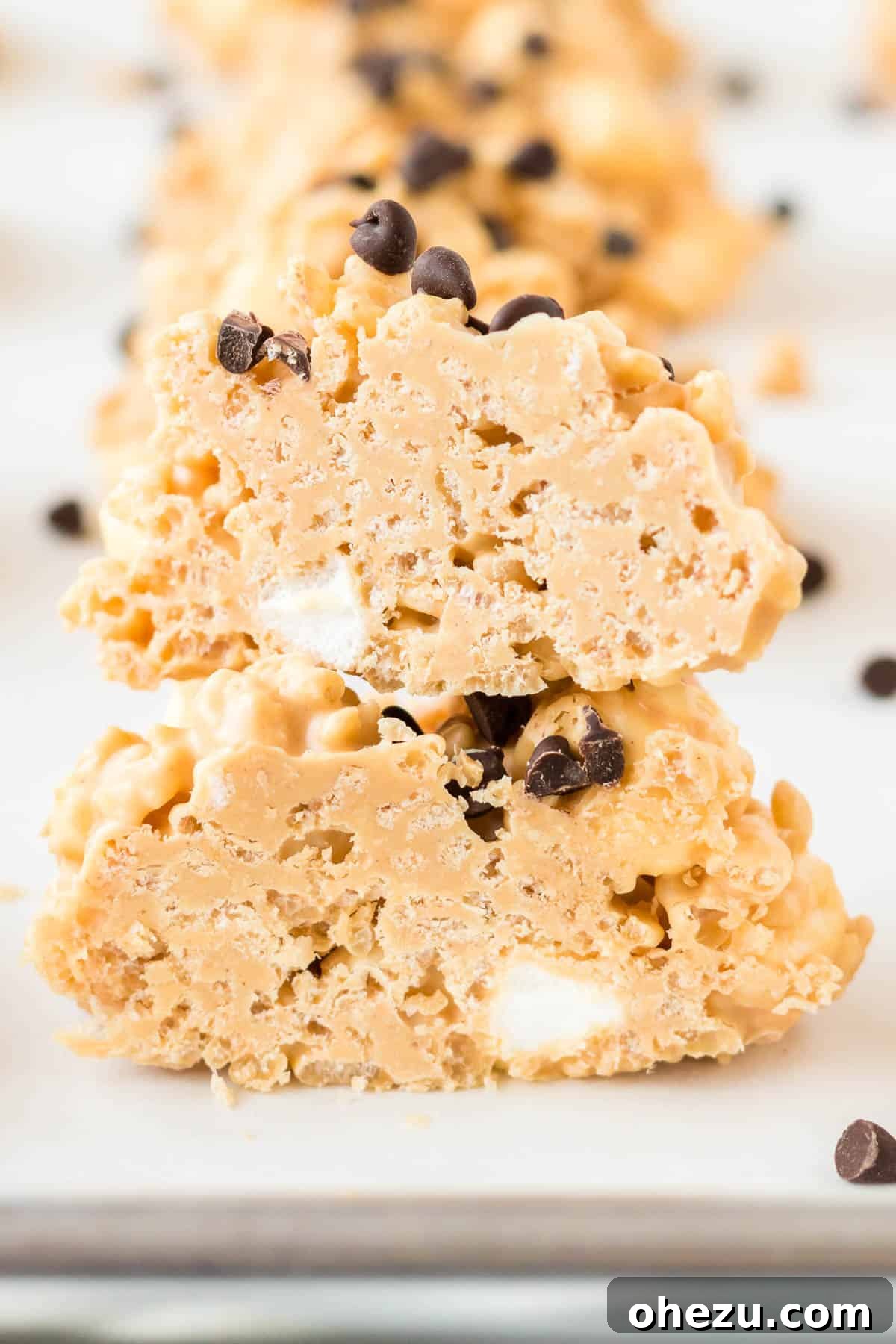 Kitchen Sink Cookies 13 A no bake avalanche cookie cut in half, revealing the soft marshmallow and crisp rice interior perfectly coated