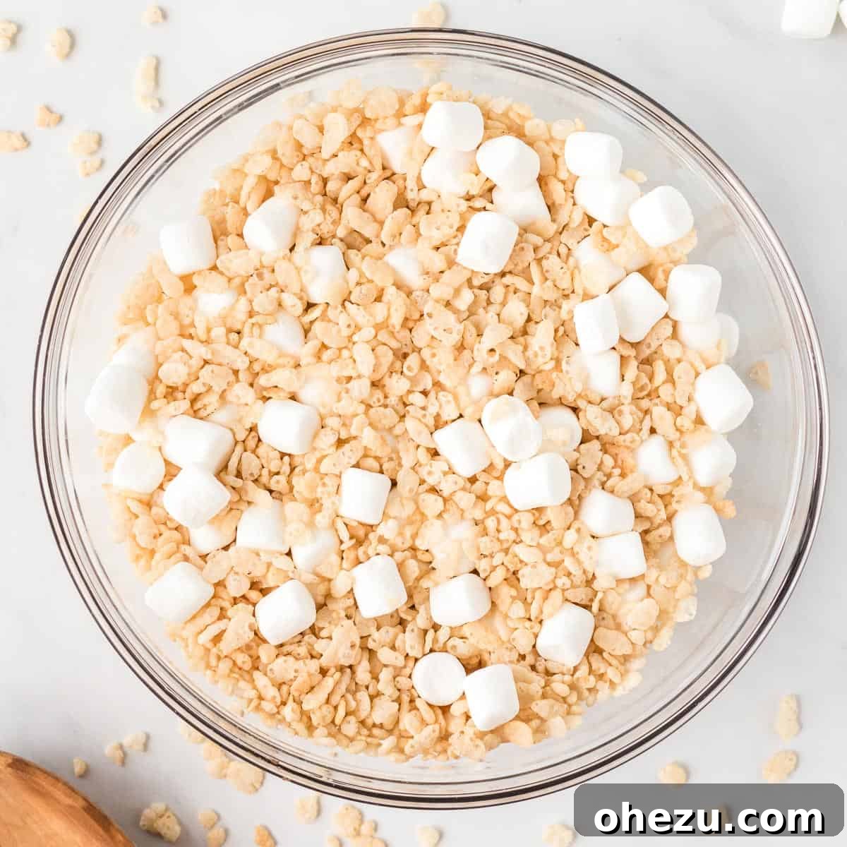 Kitchen Sink Cookies 5 Mini marshmallows and crisp rice cereal mixed together in a large glass bowl