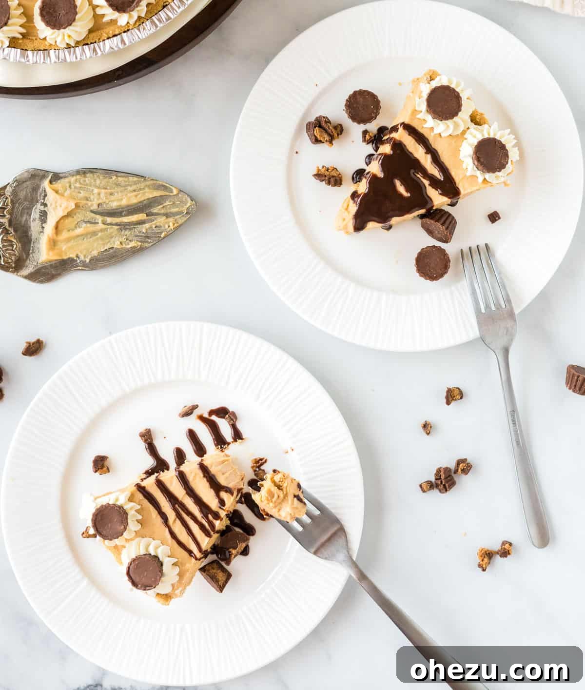 Two pristine white plates, each gracefully holding a perfect slice of no bake peanut butter pie, garnished with a delicate chocolate drizzle, elegantly arranged and ready for serving.