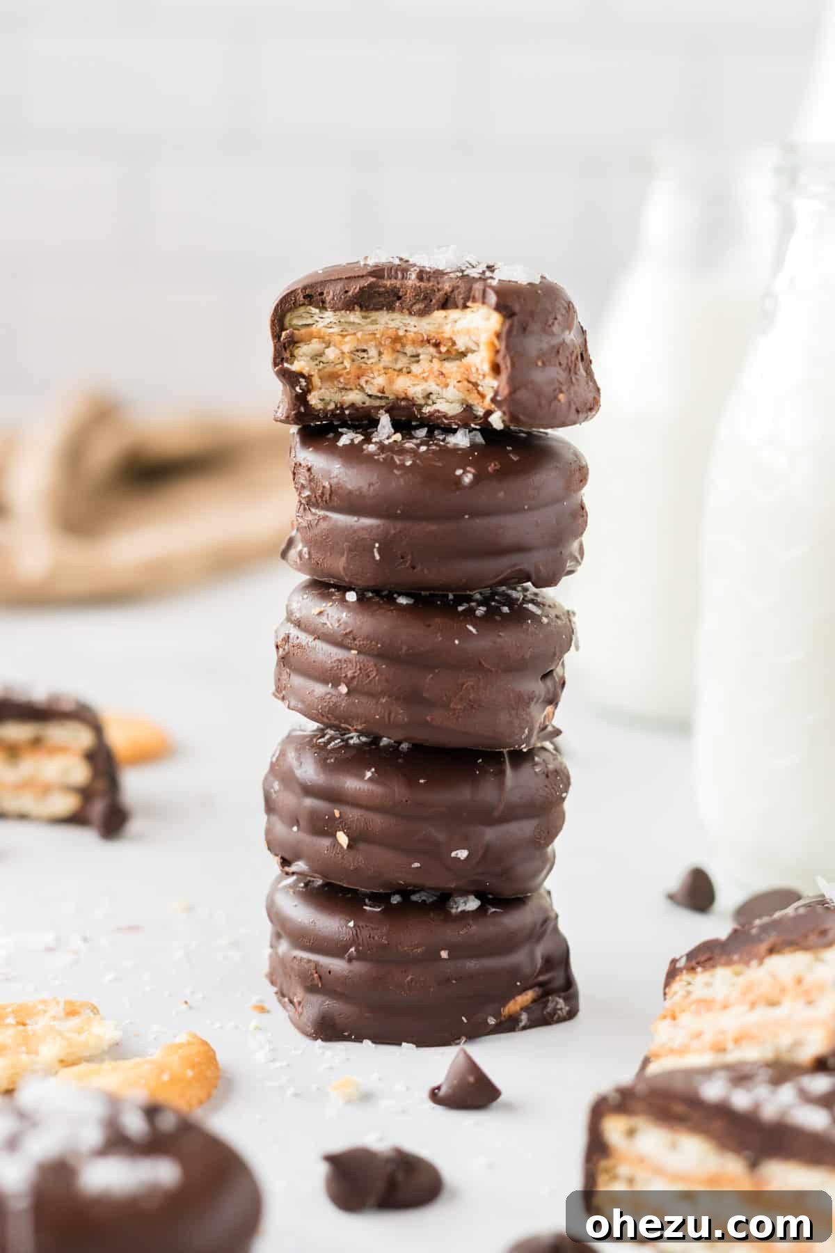 Stacked Ritz Cracker Cookies with one missing a bite, showcasing the peanut butter filling.