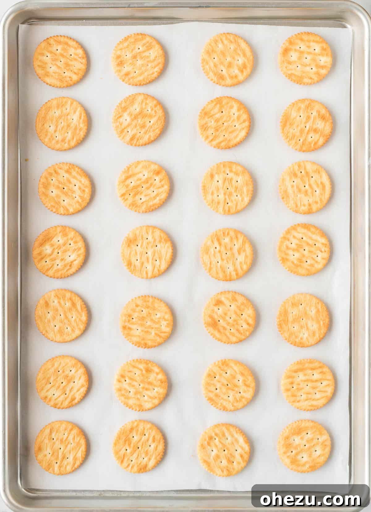 Ritz cracker cookie sandwiches being assembled on a baking sheet