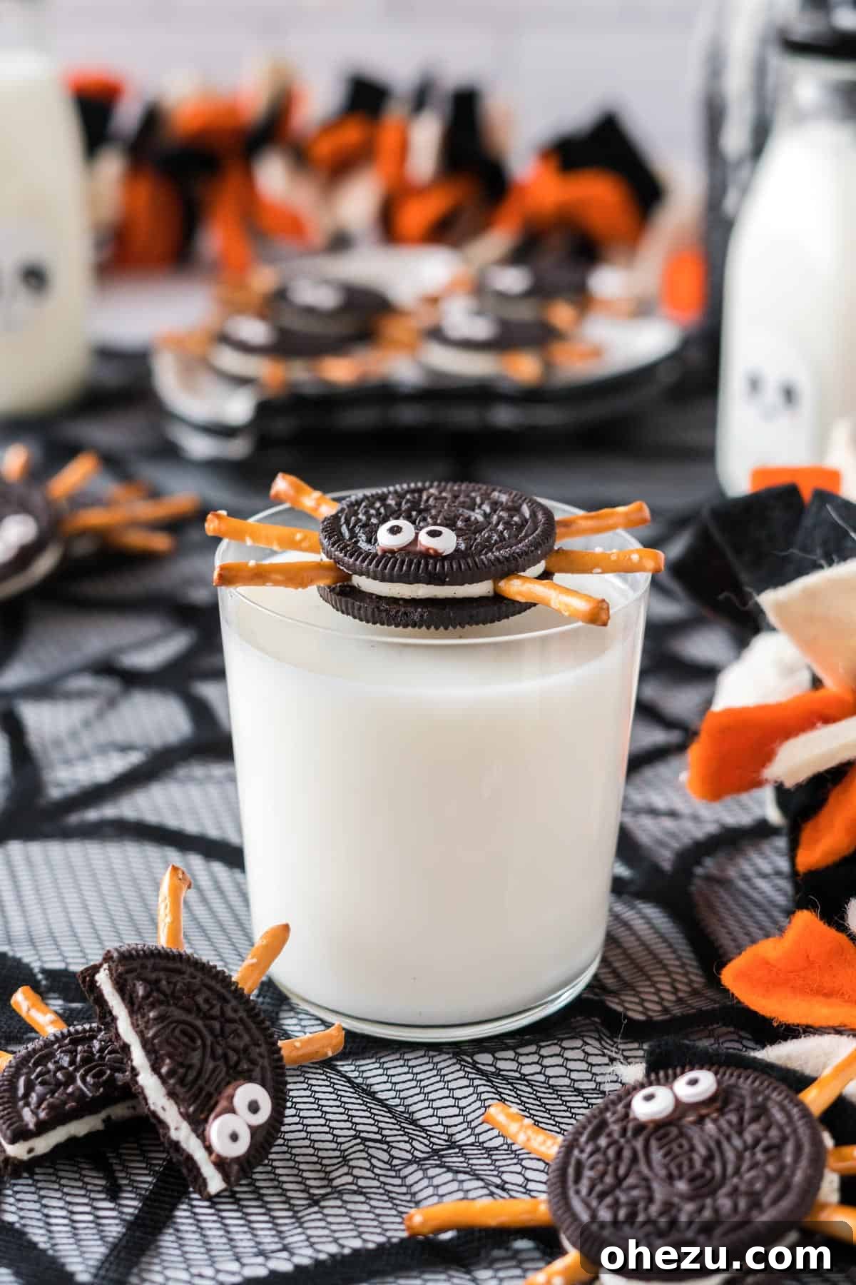 Spooky Oreo Spiders 2 Oreo spider cookie with pretzel legs and candy eyes perched on a glass of milk