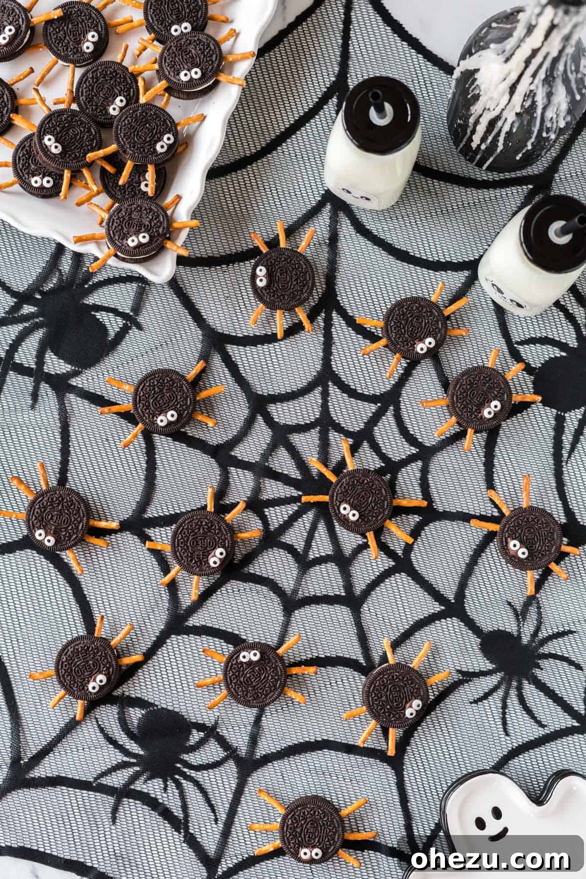 Spooky Oreo Spiders 11 A group of Oreo spider cookies on a decorative cobweb background, creating a spooky ambiance
