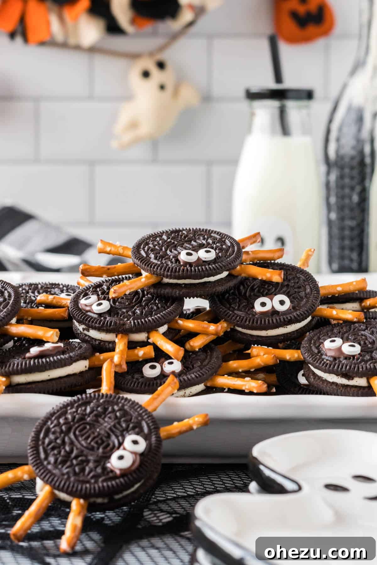 Spooky Oreo Spiders 14 Close-up view of Oreo spider cookies on a white serving tray, highlighting their details