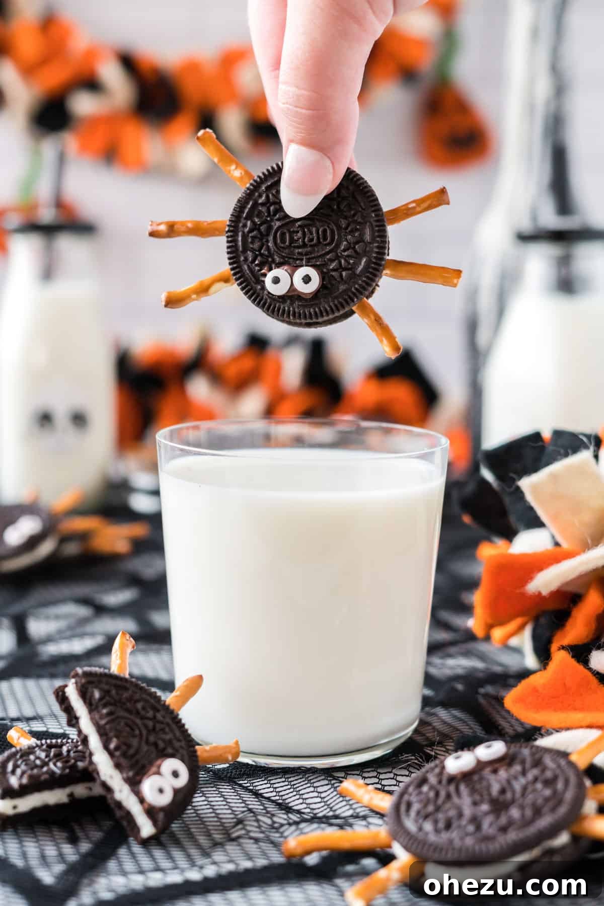 Spooky Oreo Spiders 15 An Oreo spider cookie next to a glass of milk, ready for dipping