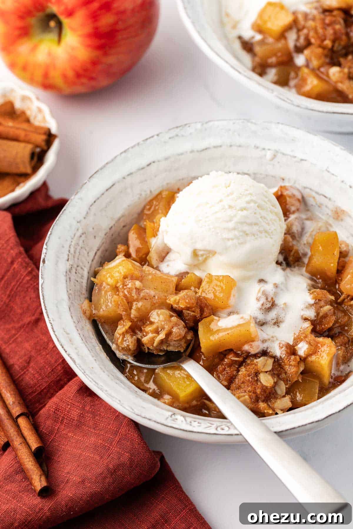A final, mouth-watering image of the vegan apple crisp with melted ice cream, ready to be enjoyed.
