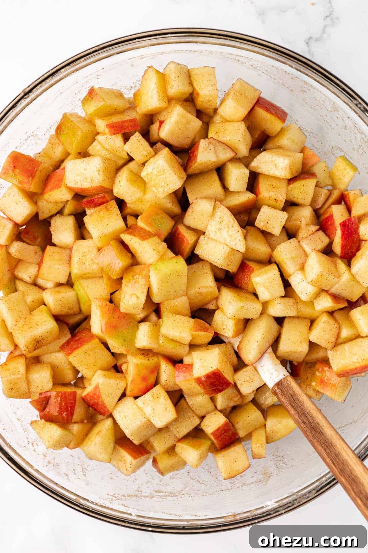 The spiced apple filling mixture in a bowl, thoroughly combined and ready.