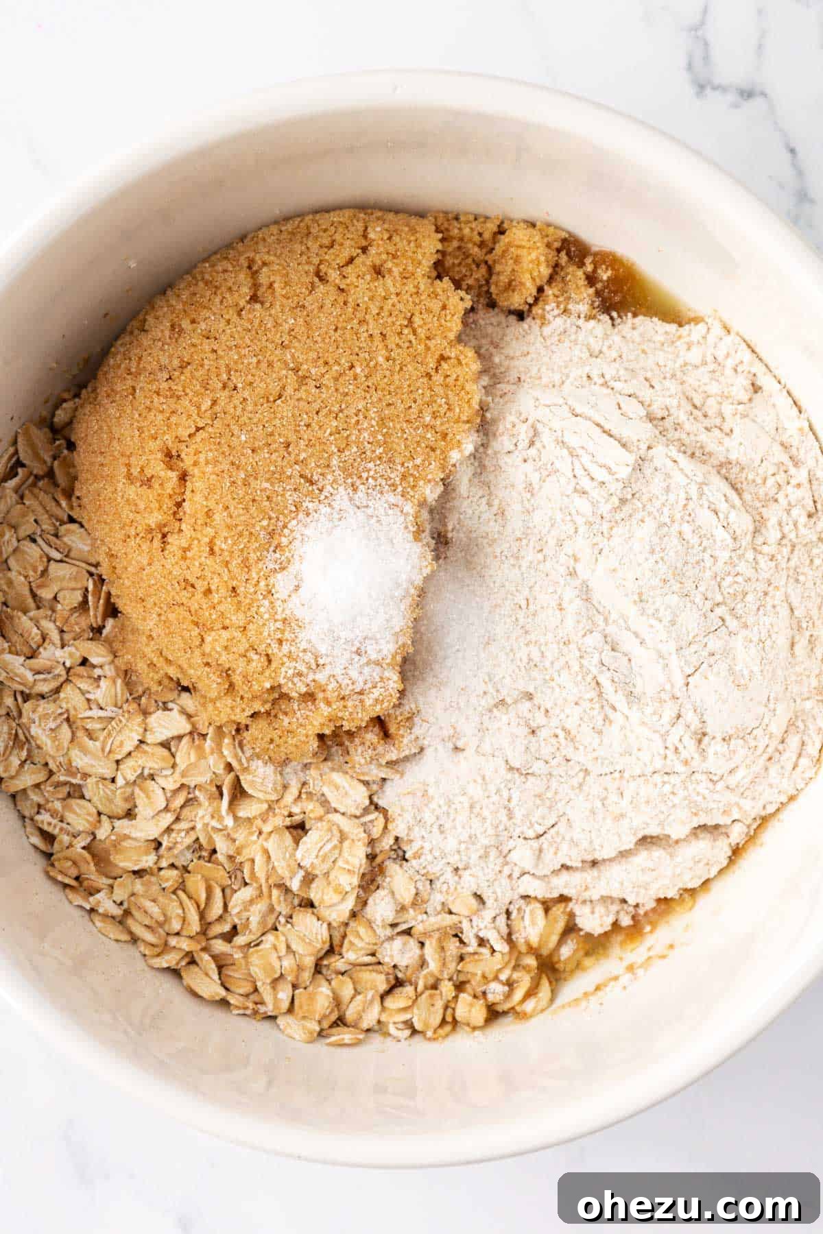 Crisp topping dry ingredients, including brown sugar, flour, and oats, in a mixing bowl.