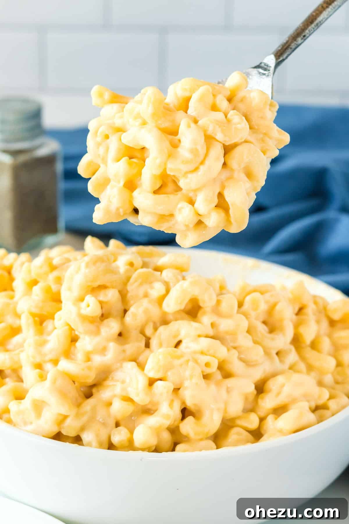 Tangy Greek Yogurt Mac and Cheese 9 serving spoon taking a scoop of mac and cheese