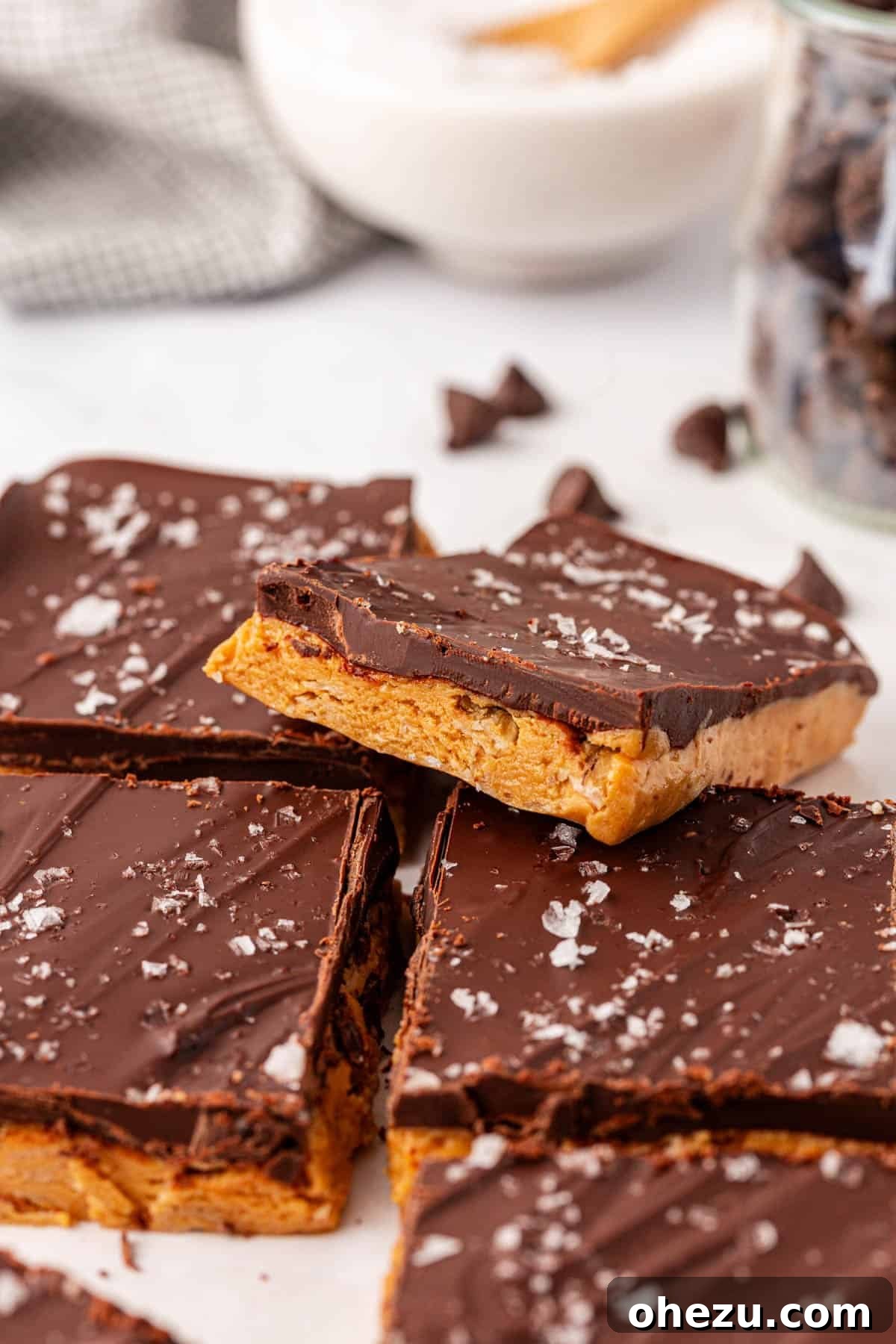 A stack of delicious no bake protein bars with a bite taken from the top one