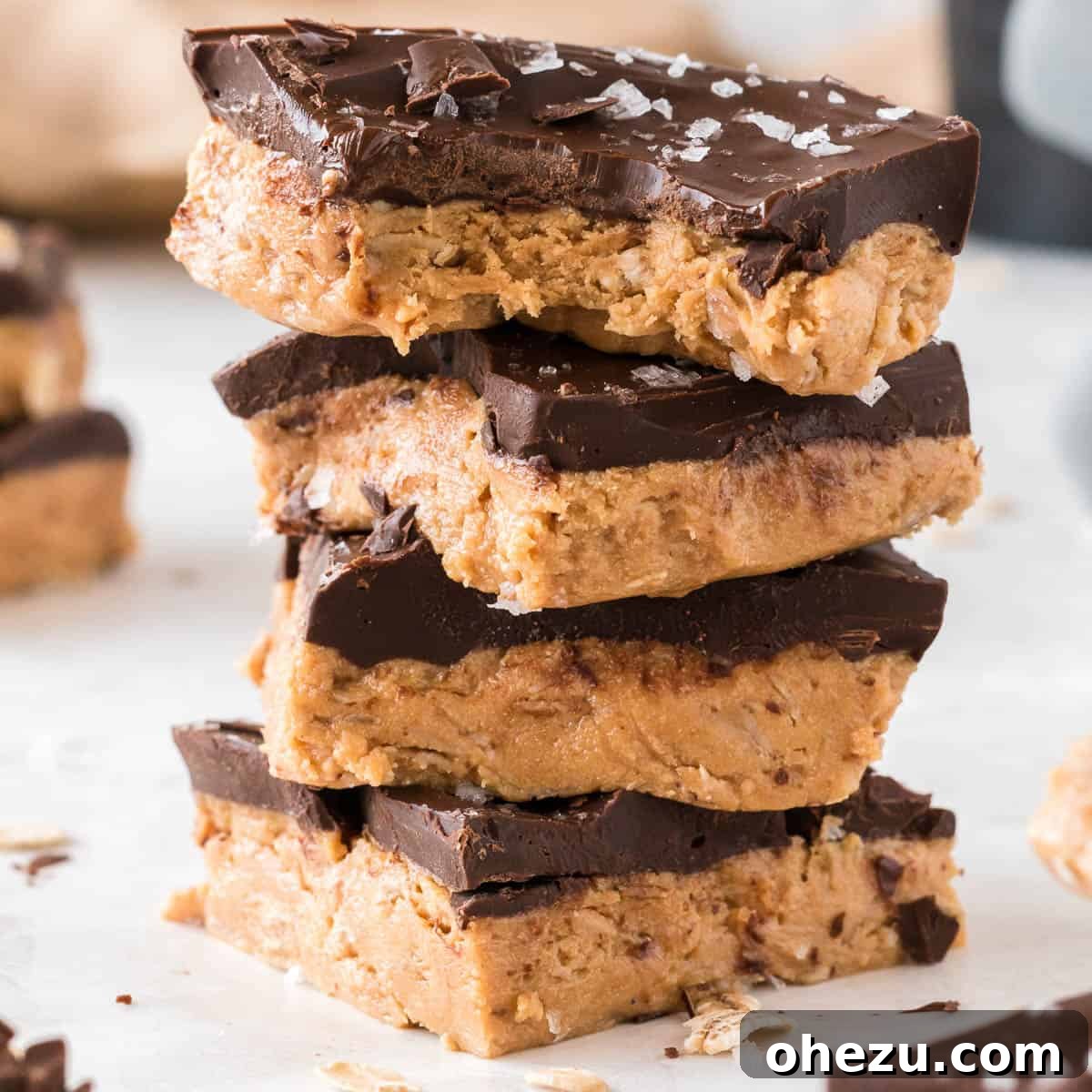 Stacked protein bars with the top one missing a bite, highlighting the delicious texture and layers