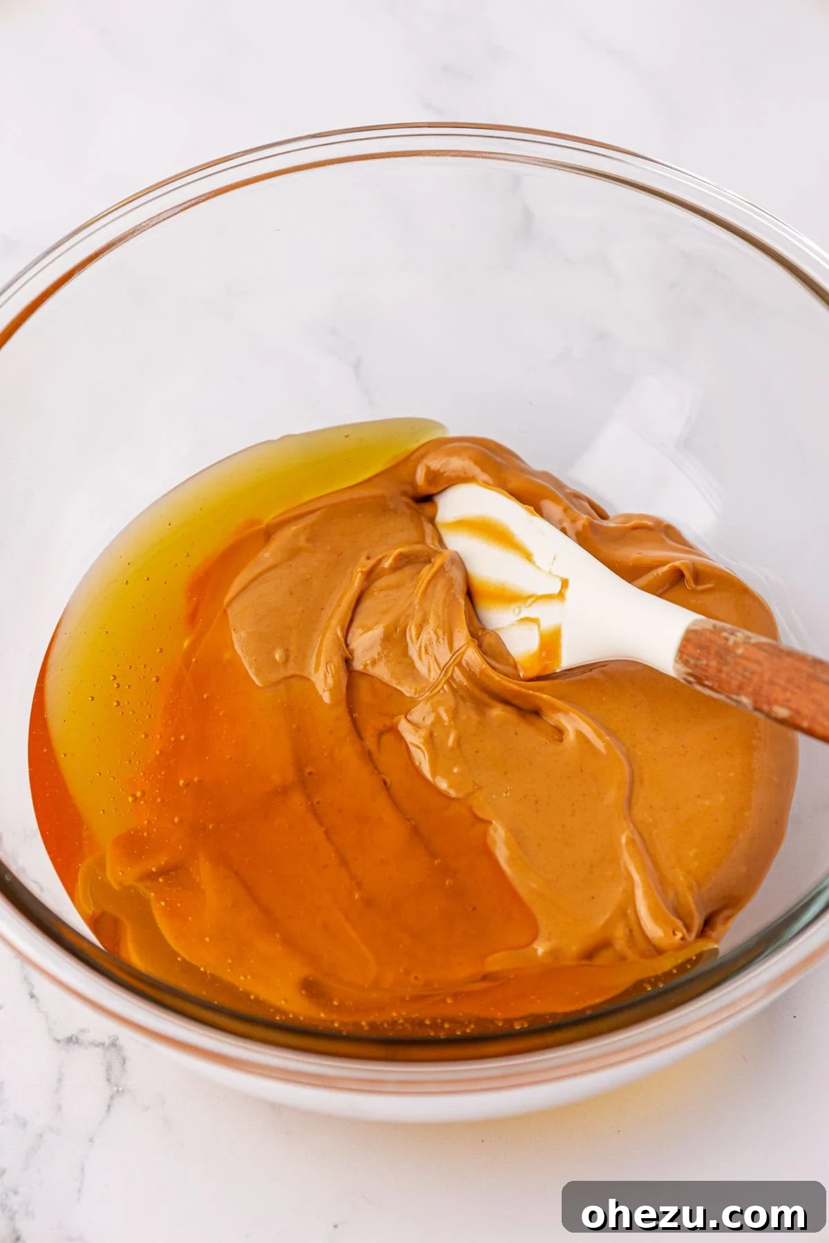 Peanut butter and honey in a mixing bowl before stirring