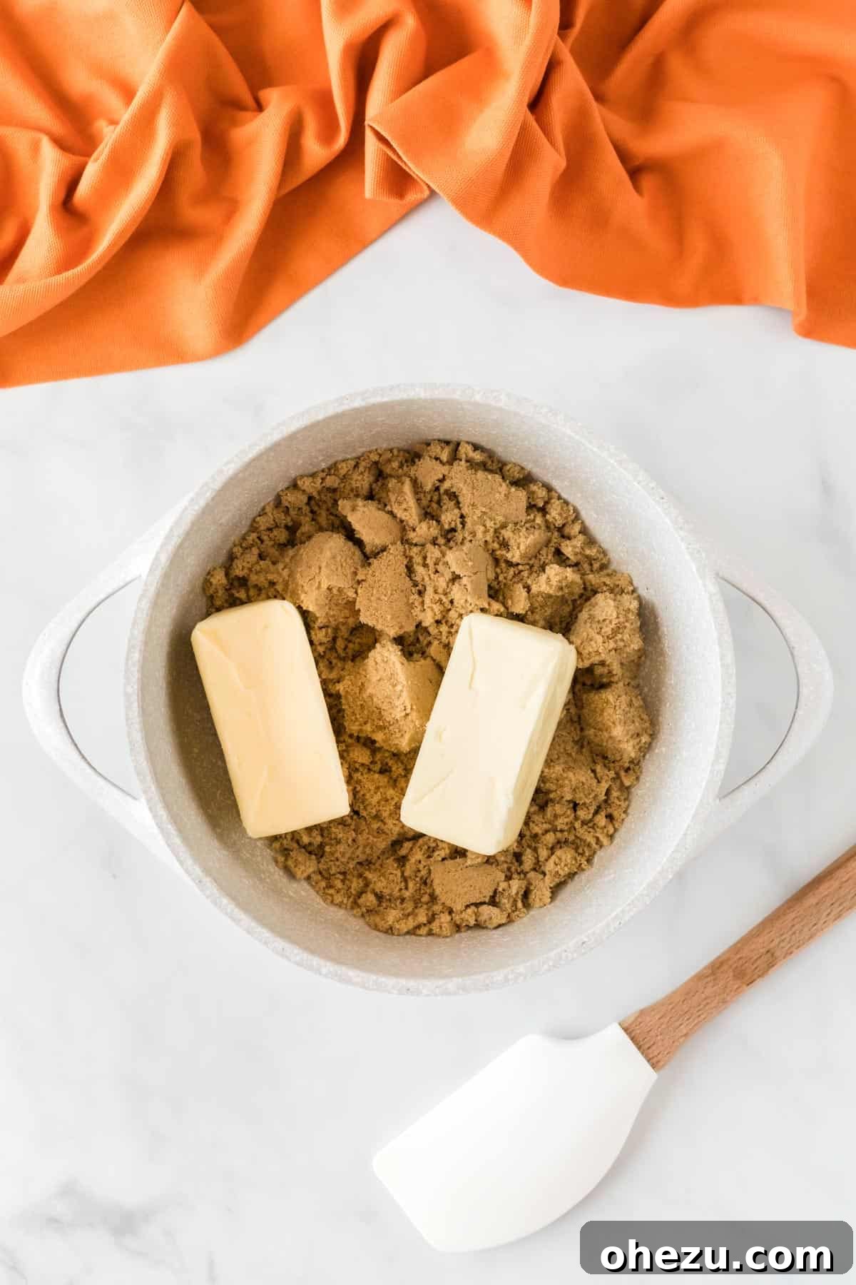 Melted brown sugar and butter bubbling in a saucepan, forming the rich toffee base for the candy.