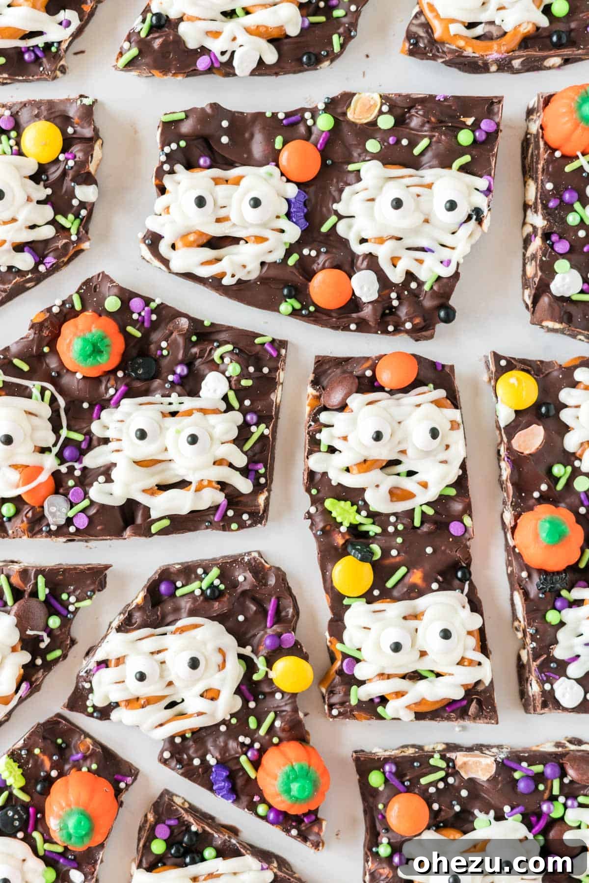 Halloween bark broken into pieces showing chocolate, pretzels, and candy
