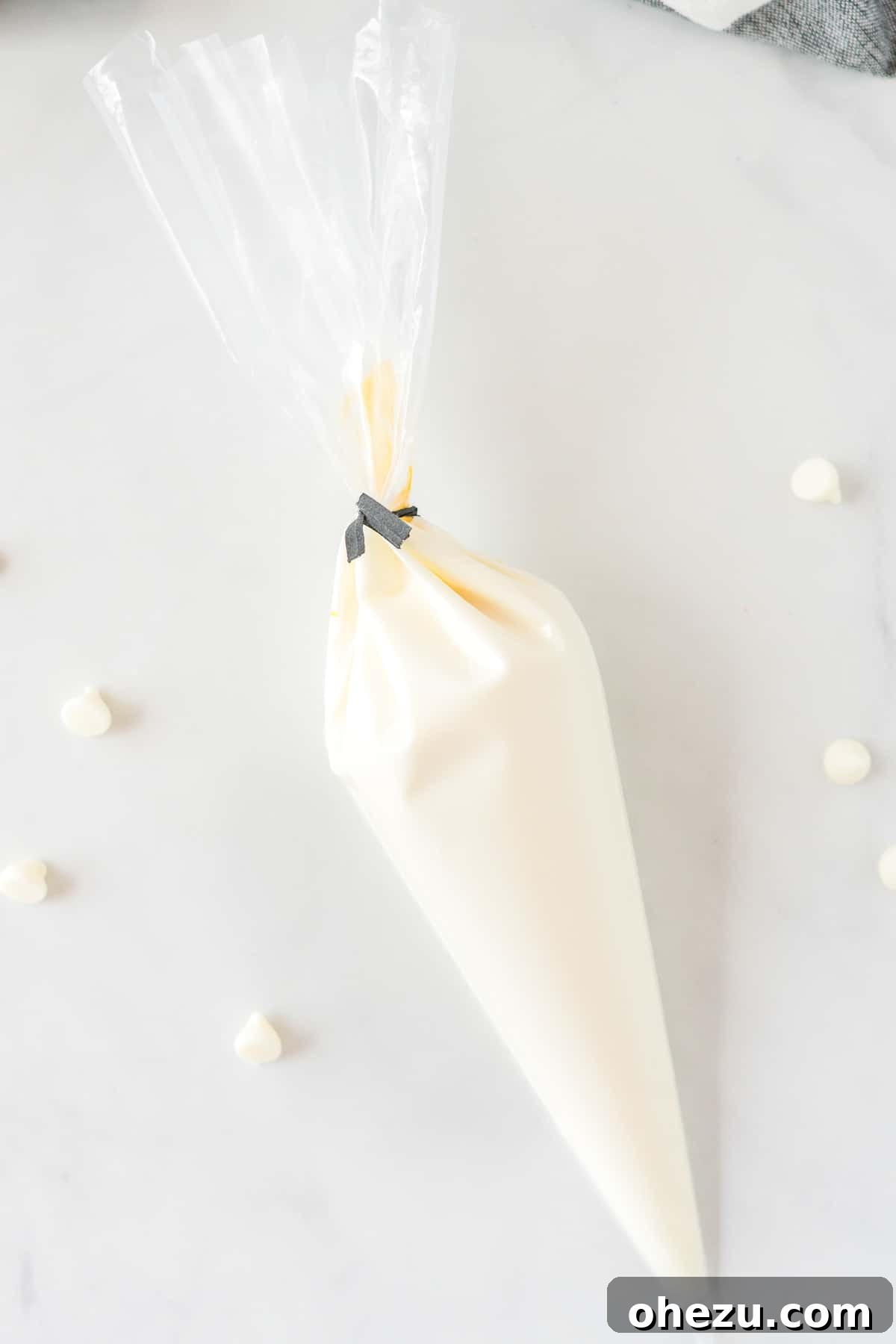 Melted white chocolate in a piping bag, ready to drizzle