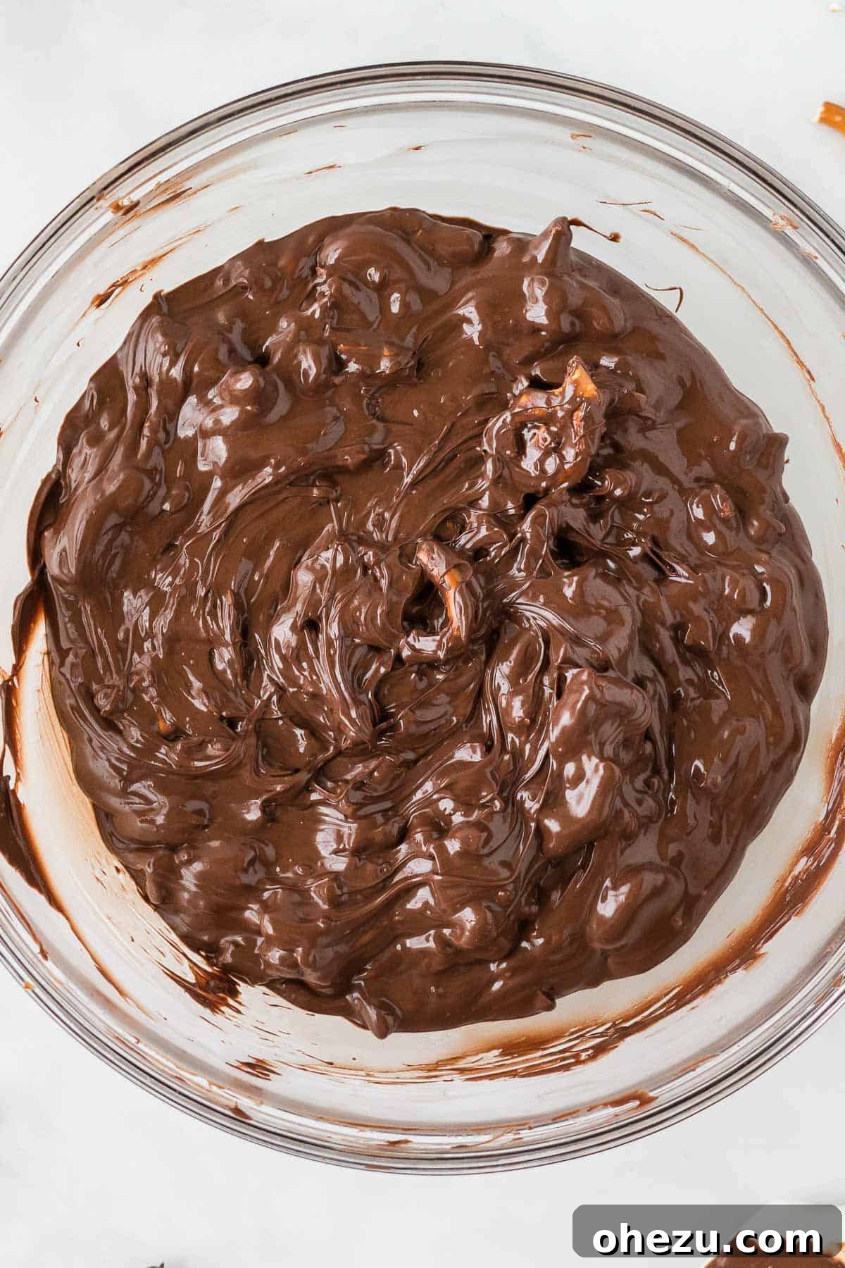 Melted chocolate and pretzels mixed together in a bowl