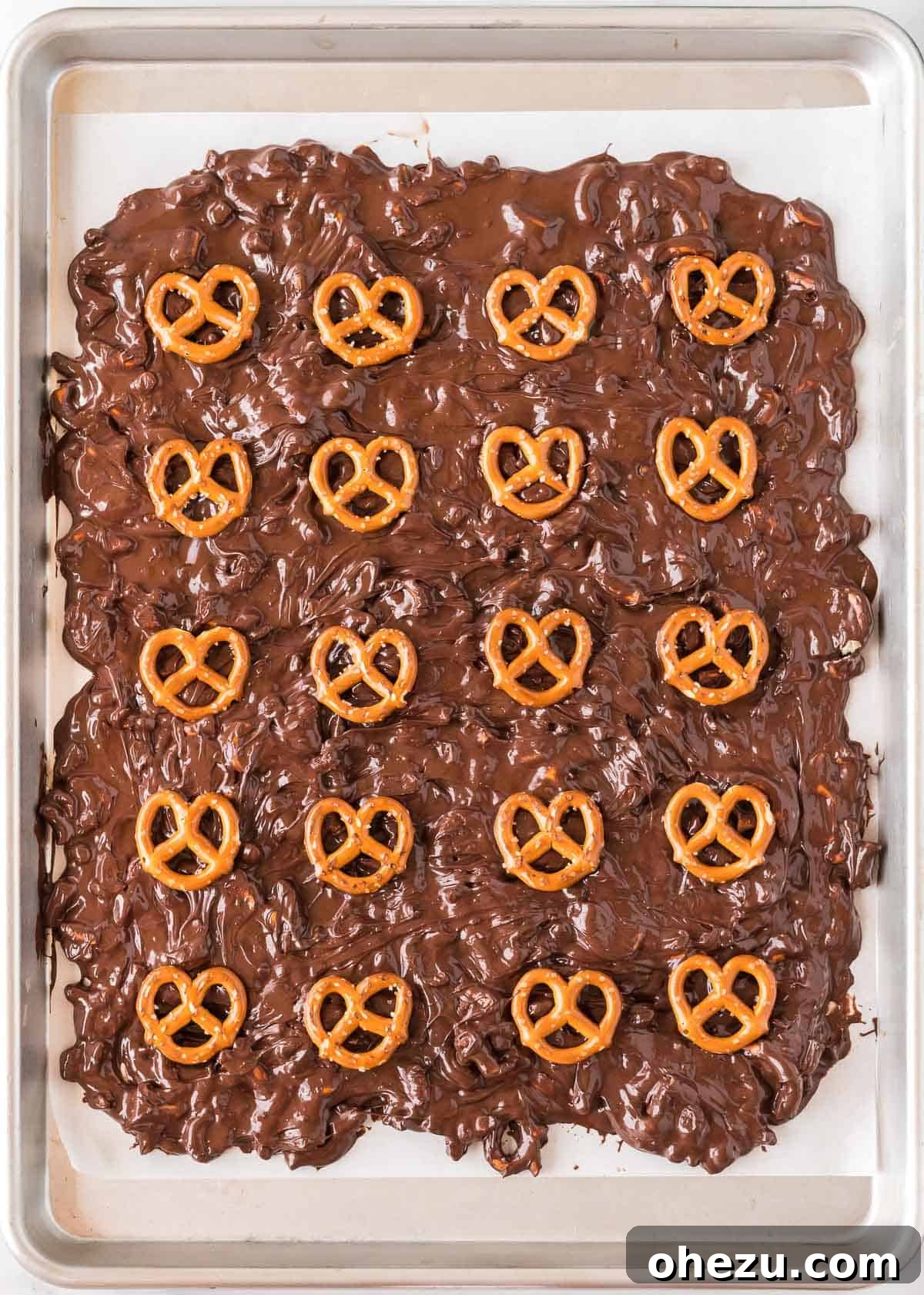 Topping the bark with whole pretzels before chilling