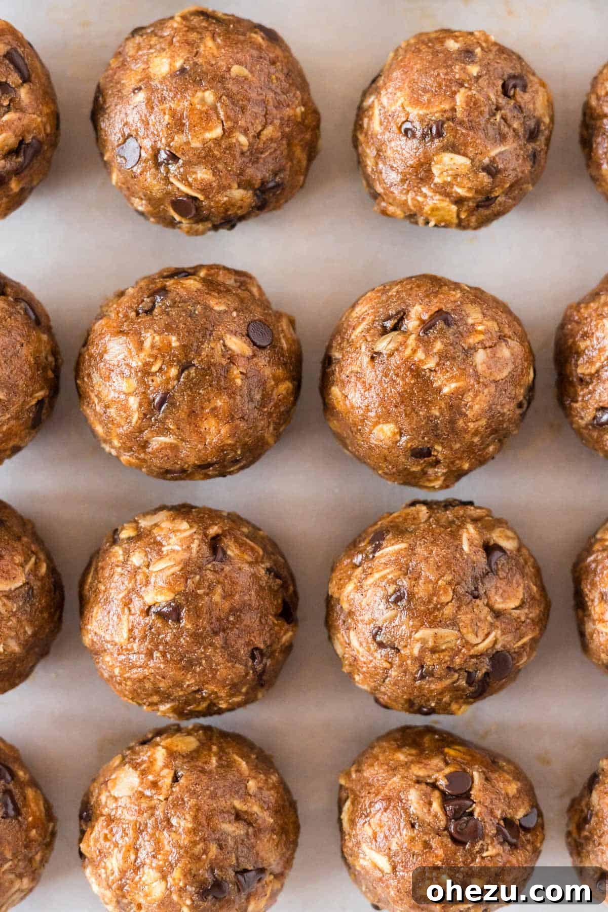 Many pumpkin protein balls artfully arranged on a baking sheet, showcasing their appeal as a healthy, homemade snack.