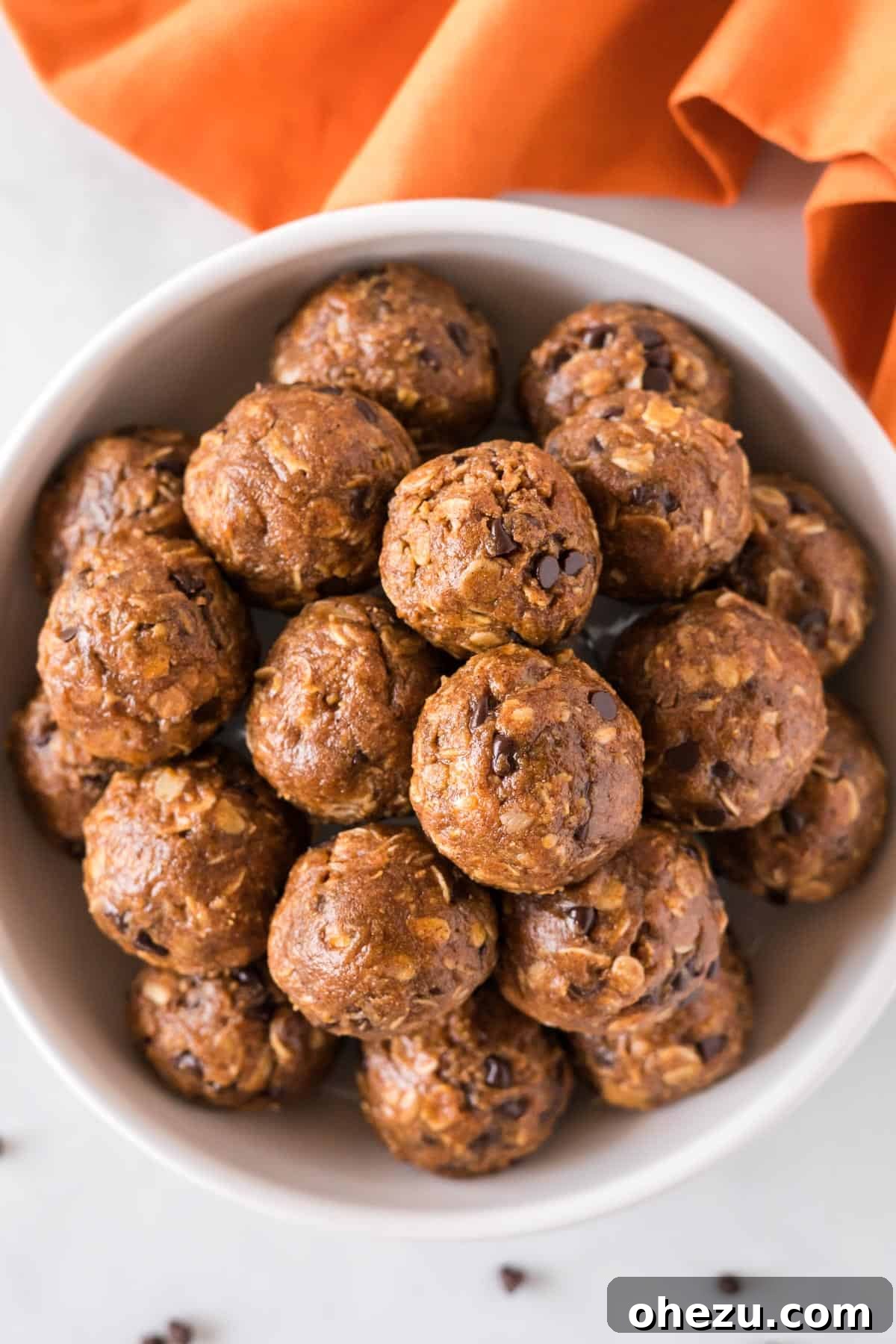 A close-up of pumpkin energy balls artfully stacked in a bowl, hinting at a delightful and healthy snack experience.