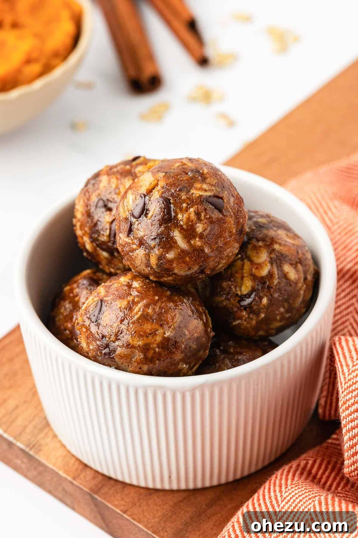 Close-up of several pumpkin protein balls, showcasing their perfectly round shape and inviting texture, ready for a healthy snack.