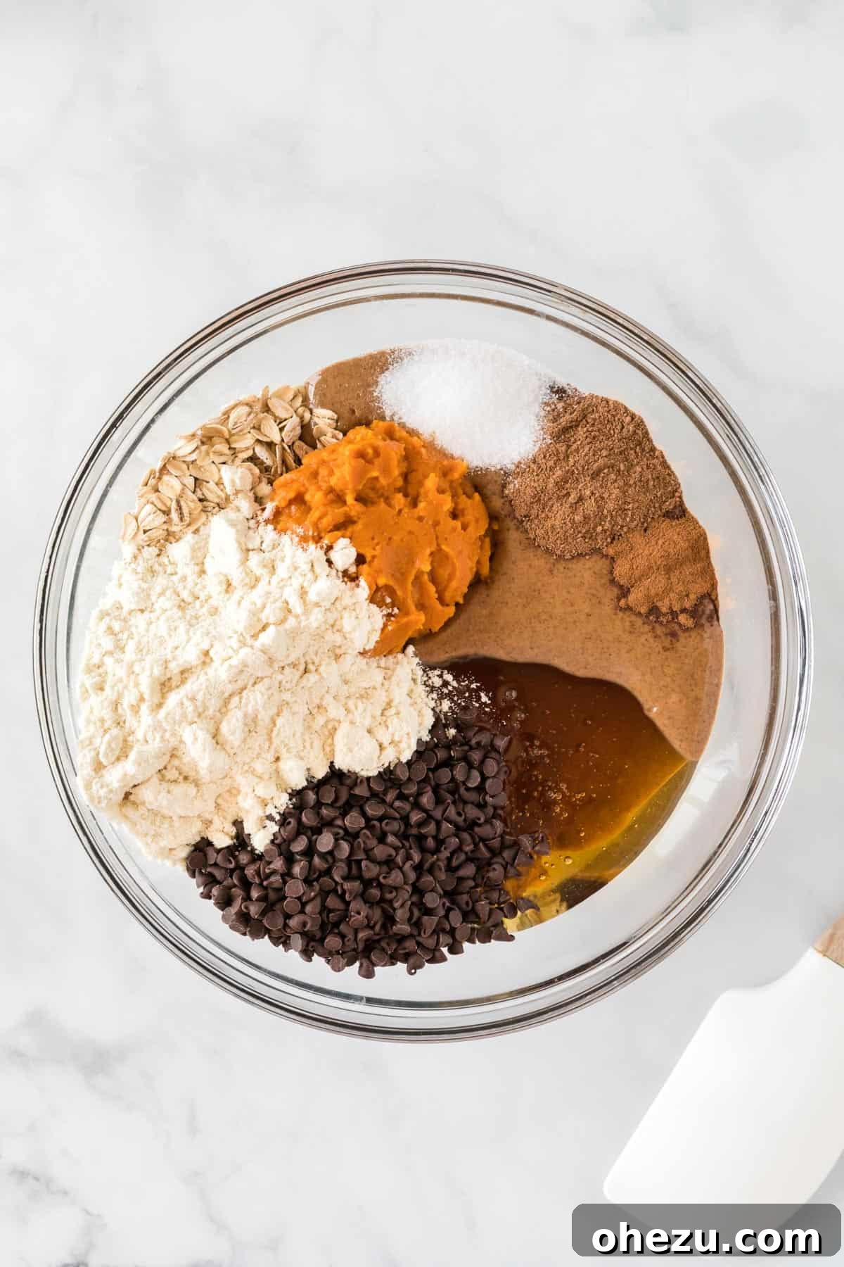 All the pumpkin protein ball ingredients mixed together in a large bowl, showing a thick, uniform dough ready for shaping.