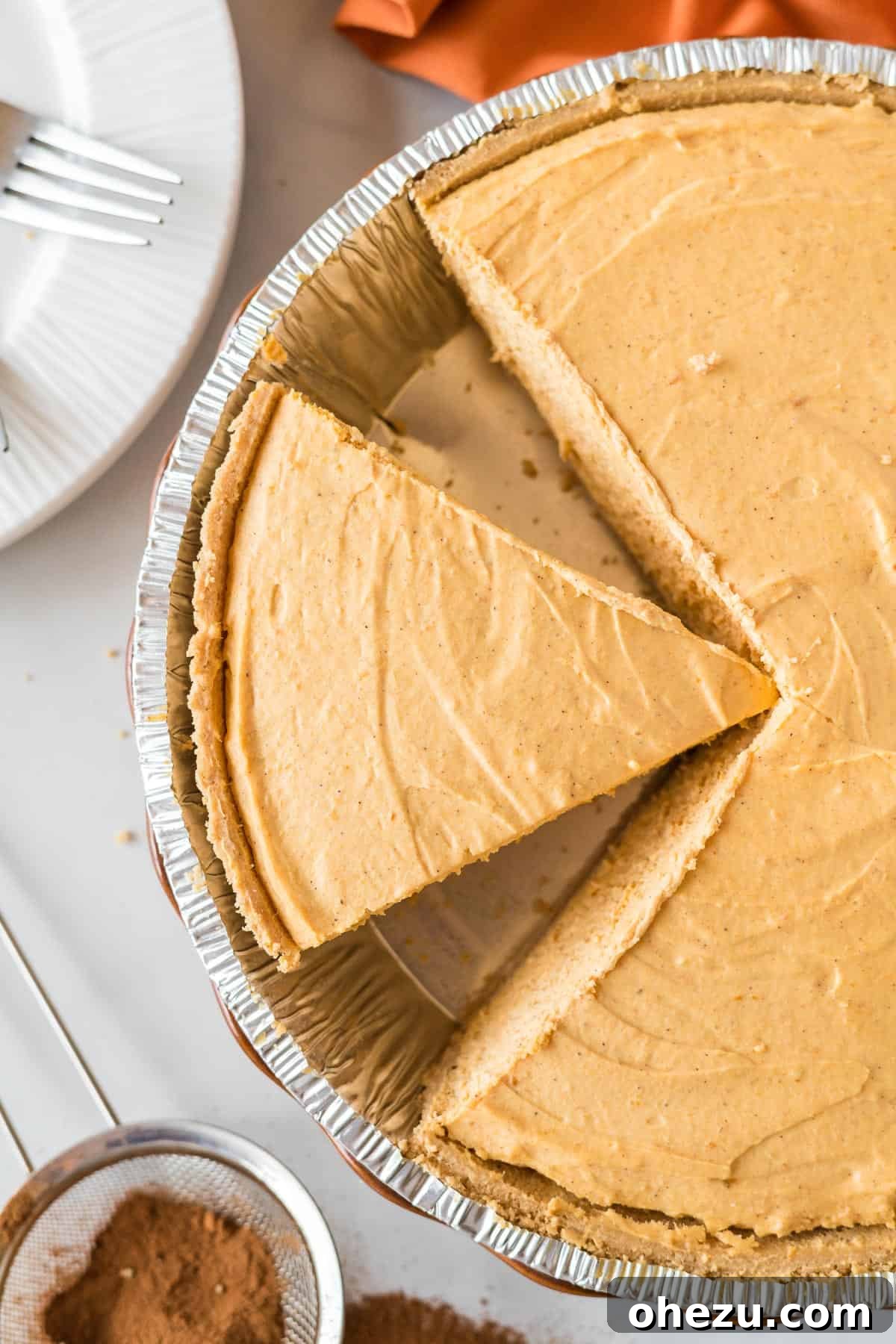 Velvet Pumpkin Pie 13 A glorious slice of chilled pumpkin cream pie, showing its firm yet creamy texture, already cut in the pie pan.