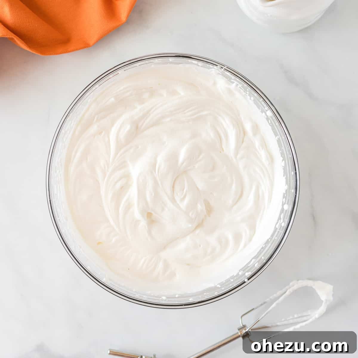 Velvet Pumpkin Pie 5 Close-up of perfectly whipped heavy cream with stiff peaks in a mixing bowl.