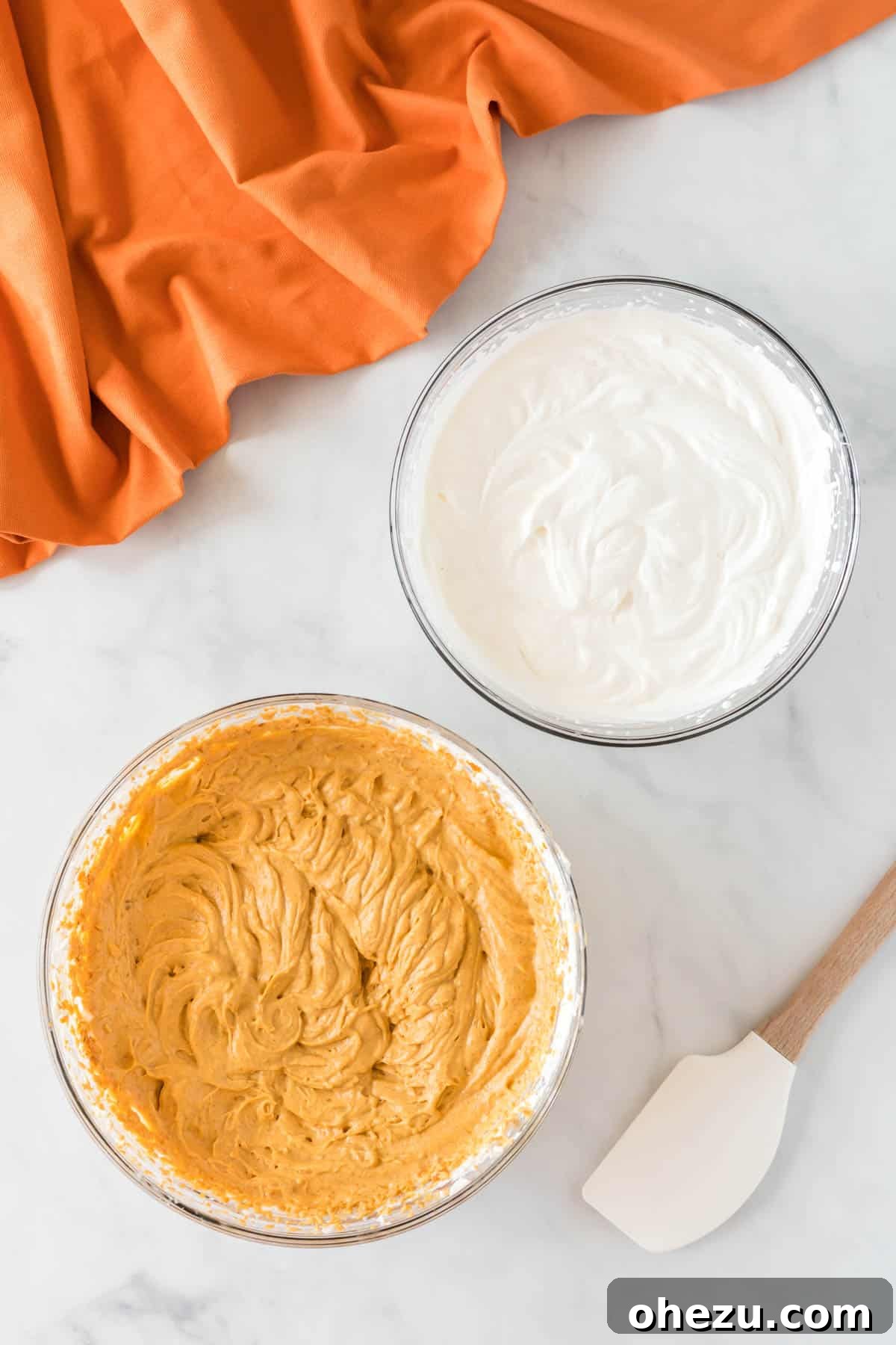 Velvet Pumpkin Pie 8 The two bowls side-by-side: whipped pumpkin cream cheese filling and a separate bowl of homemade whipped cream, ready to be combined.