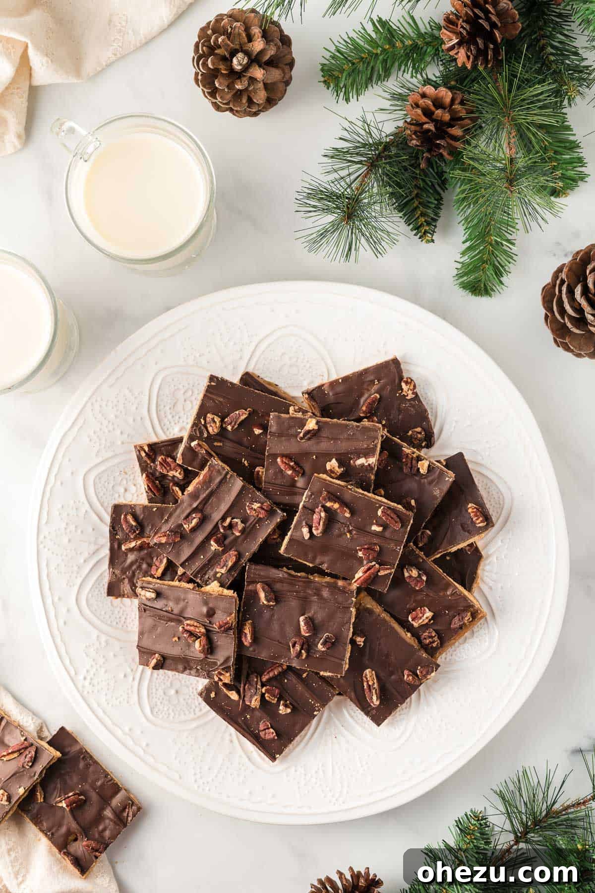 A tantalizing close-up shot of a single piece of graham cracker toffee resting on a pristine white plate, expertly highlighting its intricate texture and delicious layers.