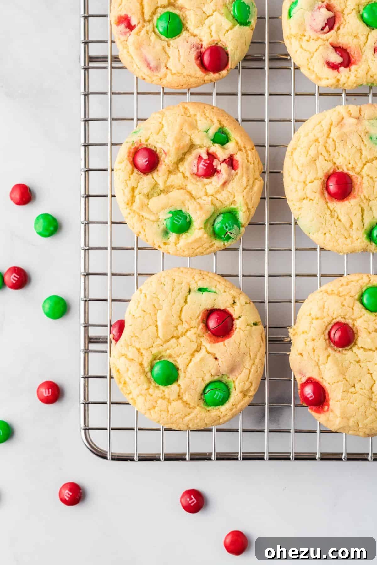 Holiday Cookie Magic from a Box 3 Freshly baked cake mix Christmas cookies cooling on a wire rack, showcasing their vibrant M&M's.
