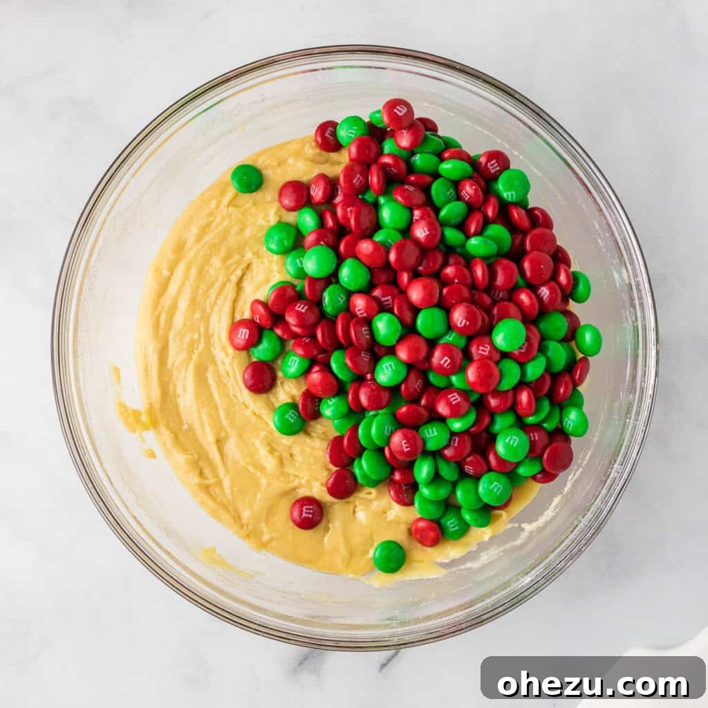 Holiday Cookie Magic from a Box 7 Adding vibrant red and green M&M's to the cake mix cookie batter for a festive touch.