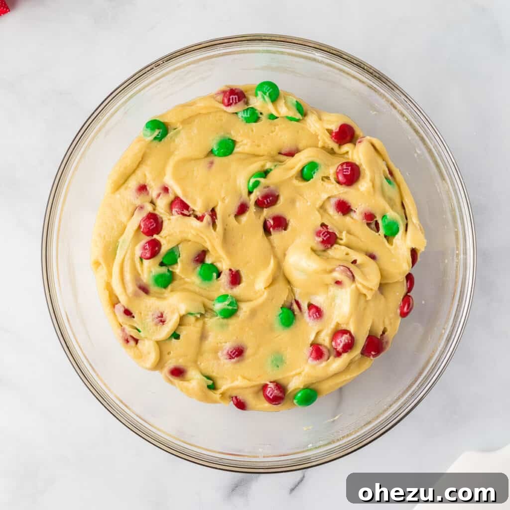 Holiday Cookie Magic from a Box 8 Christmas cookie batter with M&M's folded in, creating a colorful and irresistible dough.