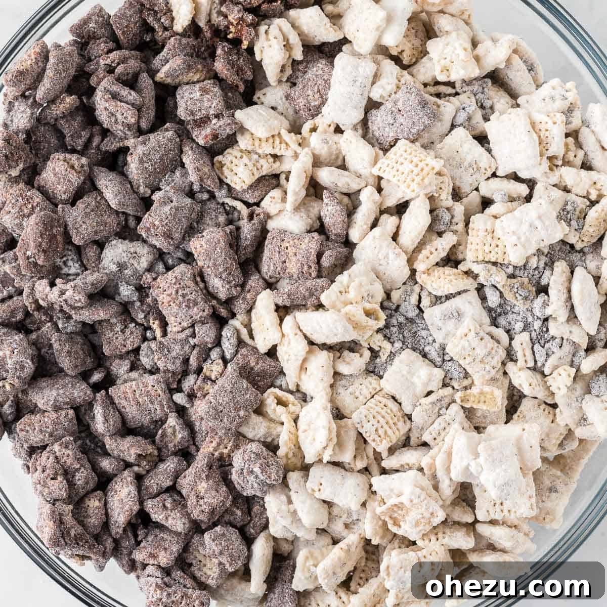 Cookies and Cream Puppy Chow 2 A large bowl filled with Cookies and Cream Muddy Buddies, a delicious mix of white chocolate and semi-sweet chocolate coated Chex cereal with crushed Oreos.