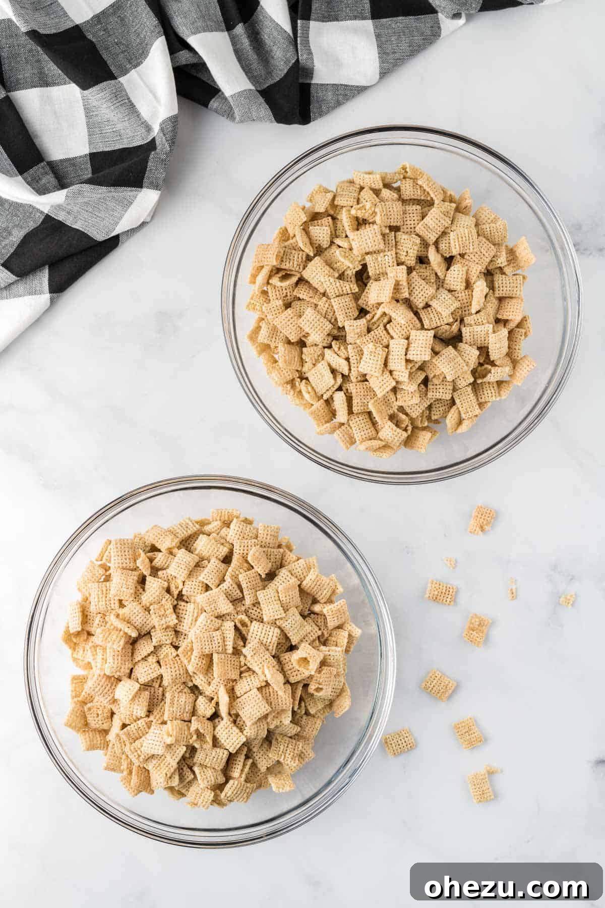 Cookies and Cream Puppy Chow 7 Two separate bowls each containing 4 cups of Rice Chex cereal, prepped for coating.