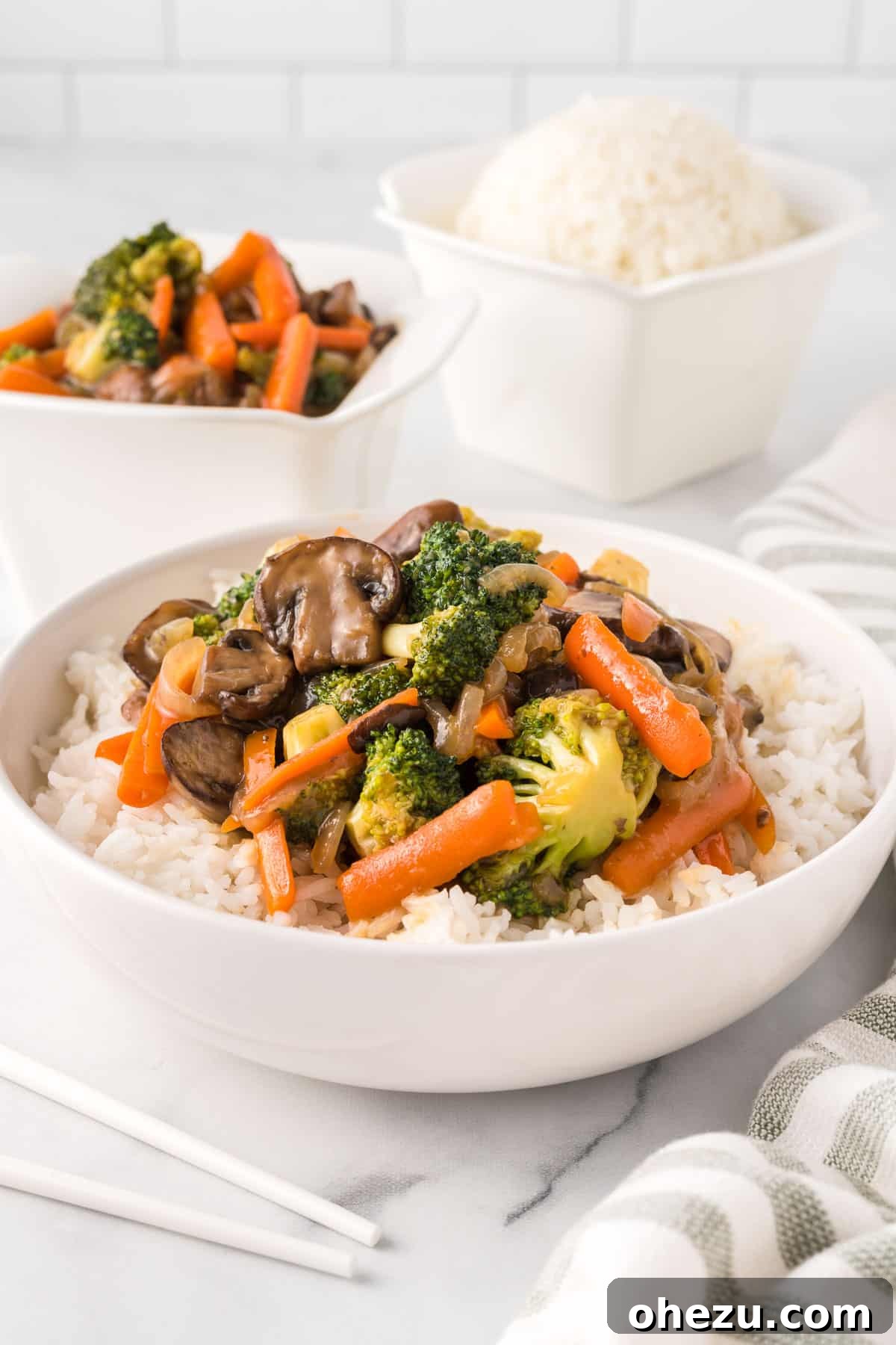 A vibrant bowl of teriyaki vegetables served over fluffy white rice, ready to be enjoyed as a wholesome and delicious meal.