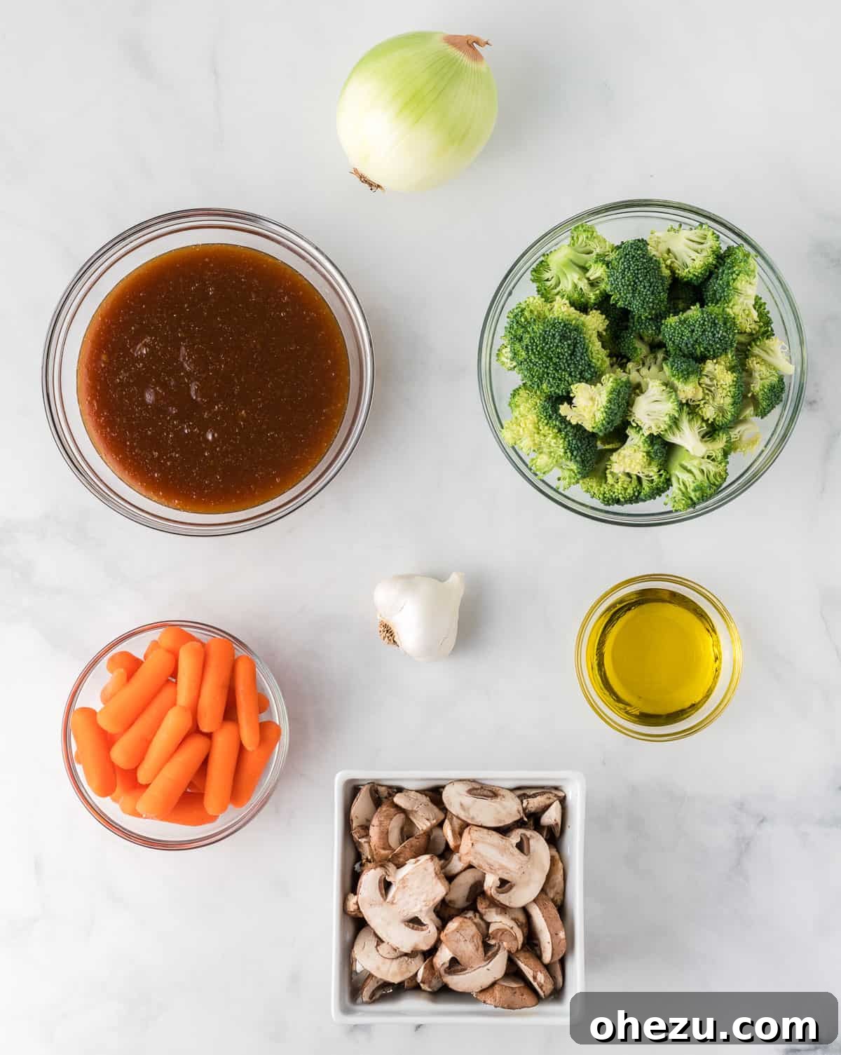 All the fresh, vibrant ingredients needed to prepare a delicious teriyaki vegetable stir fry, neatly arranged on a wooden cutting board.