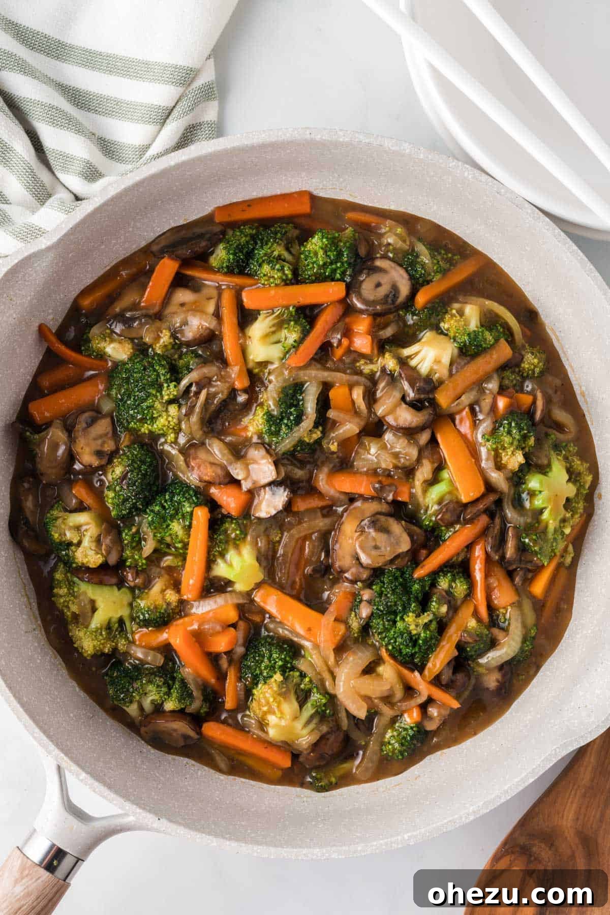 A sizzling skillet brimming with glossy, perfectly cooked teriyaki vegetables, showcasing their vibrant colors and appealing textures.