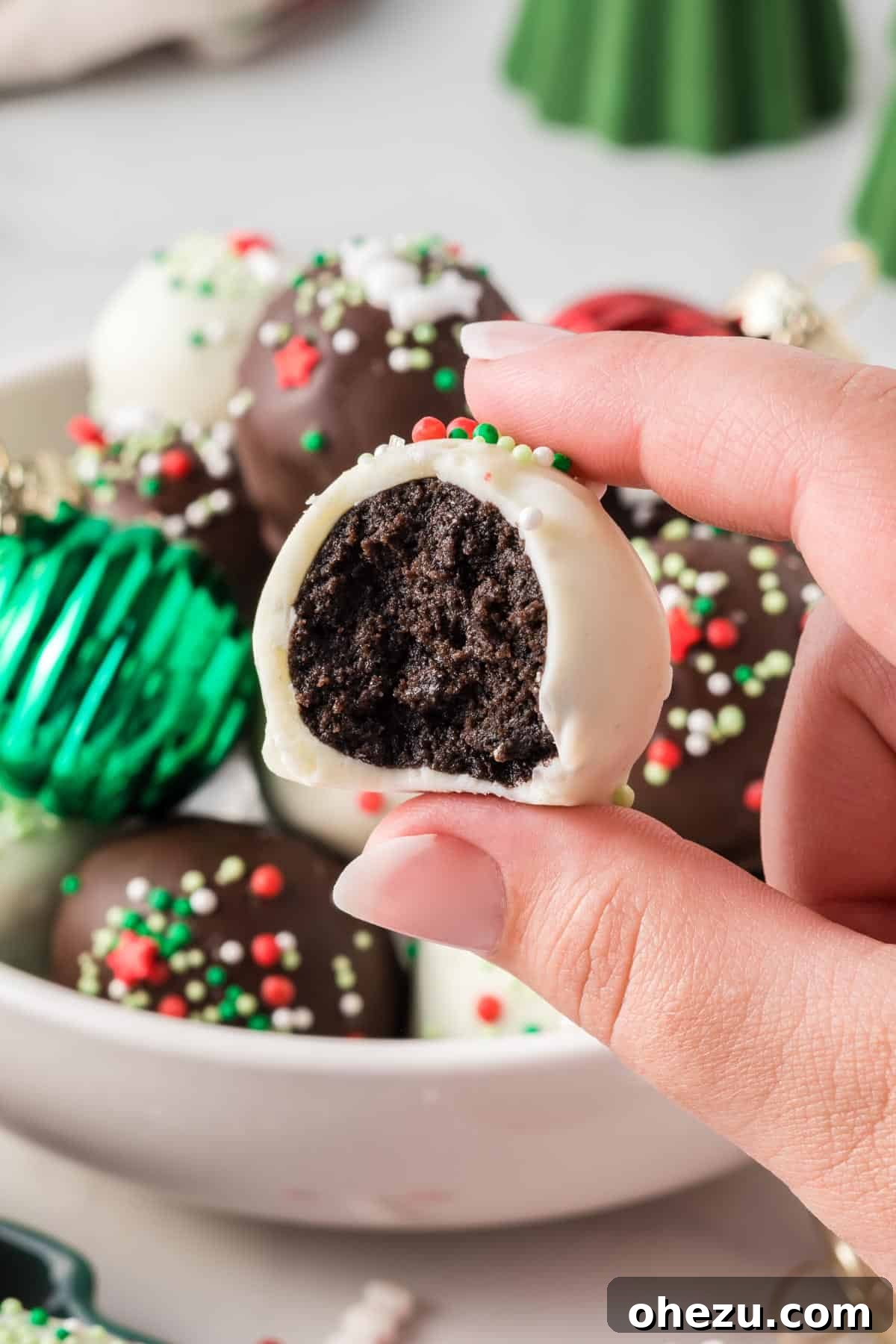 Decadent Holiday Oreo Treats 20 A delicious Oreo truffle with a bite taken out, showing its rich texture